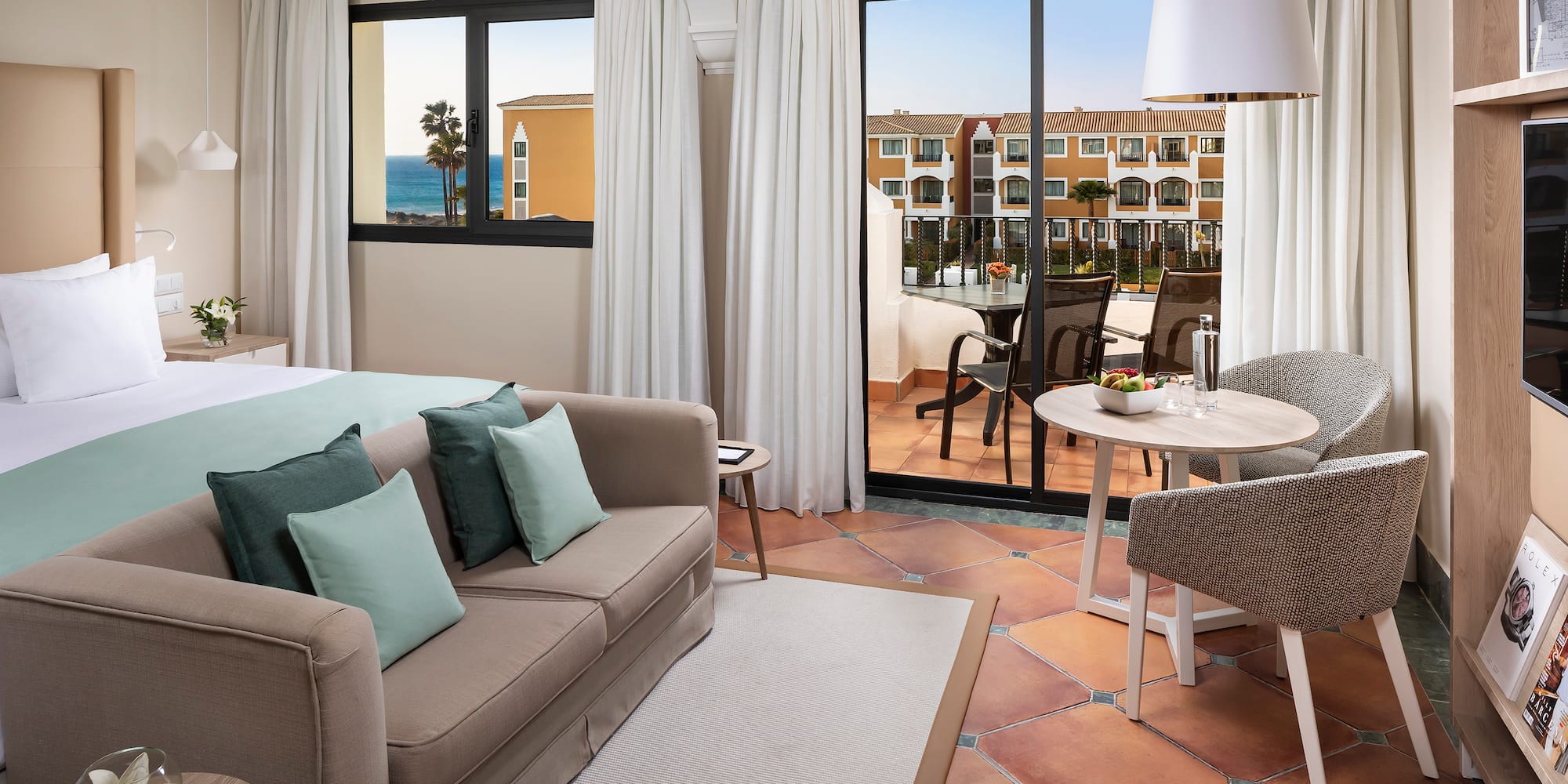 a room with a couch and a table and chairs