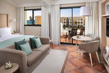 a room with a couch and a table and chairs