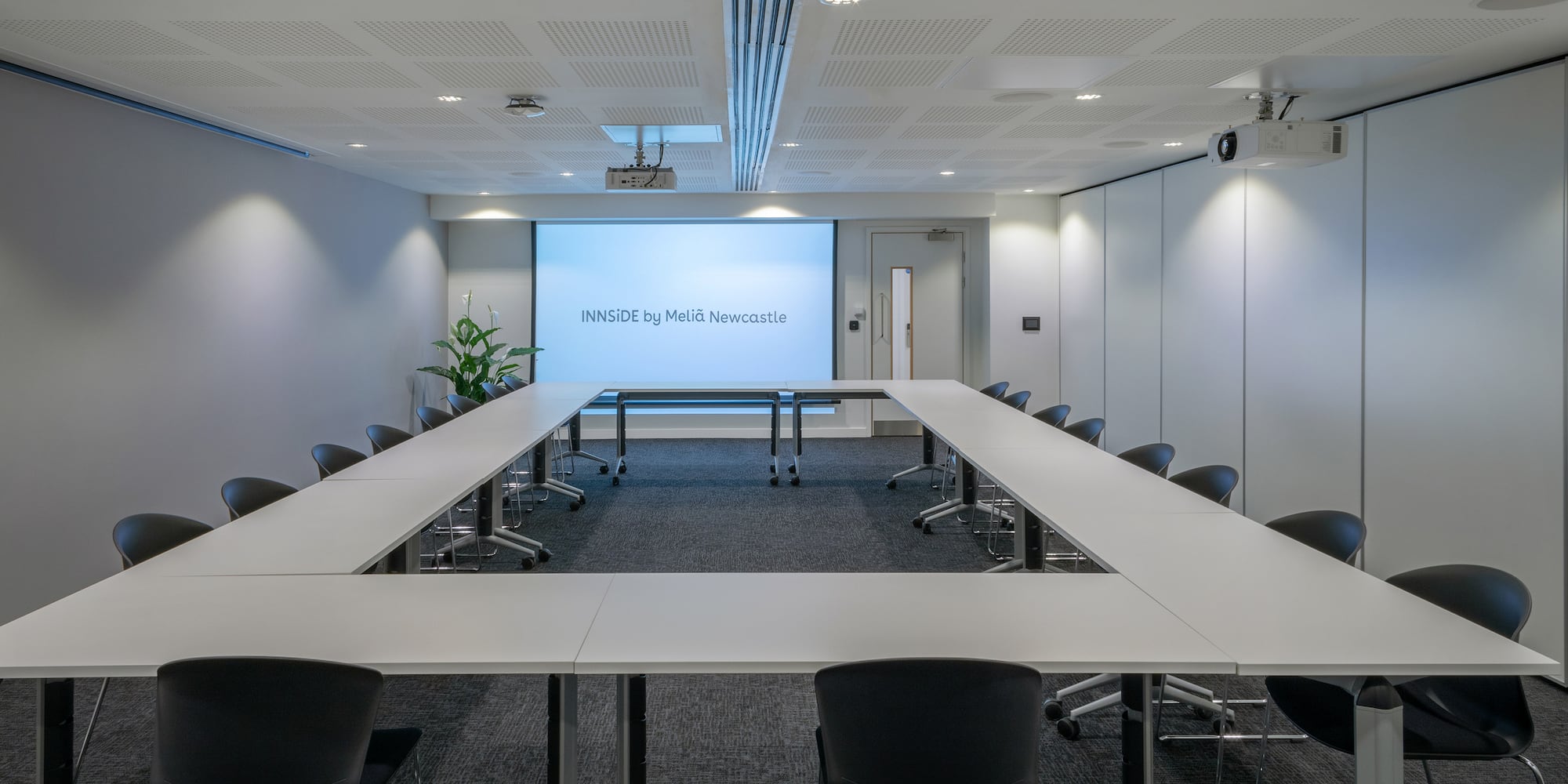 a conference room with a projection screen