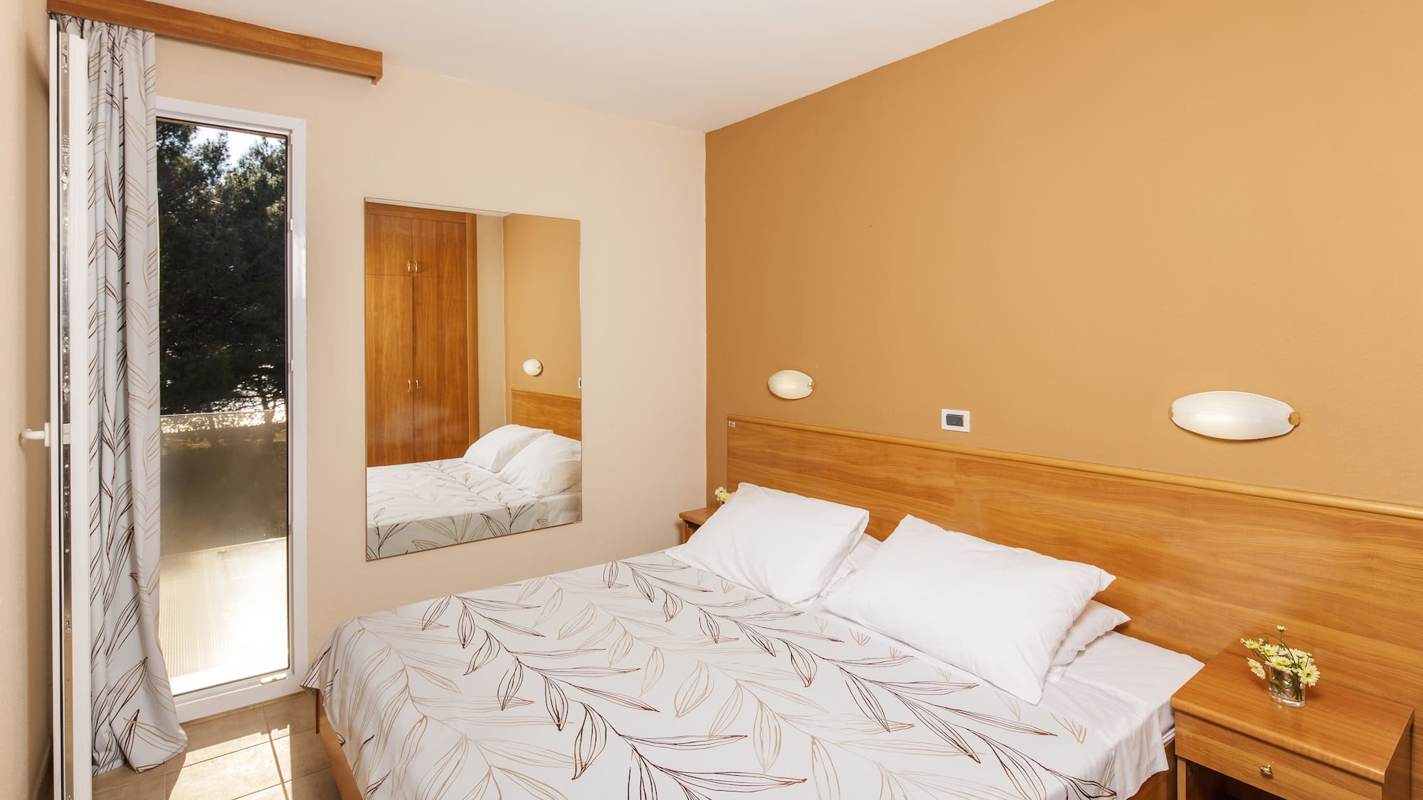 a bed with a mirror in a room