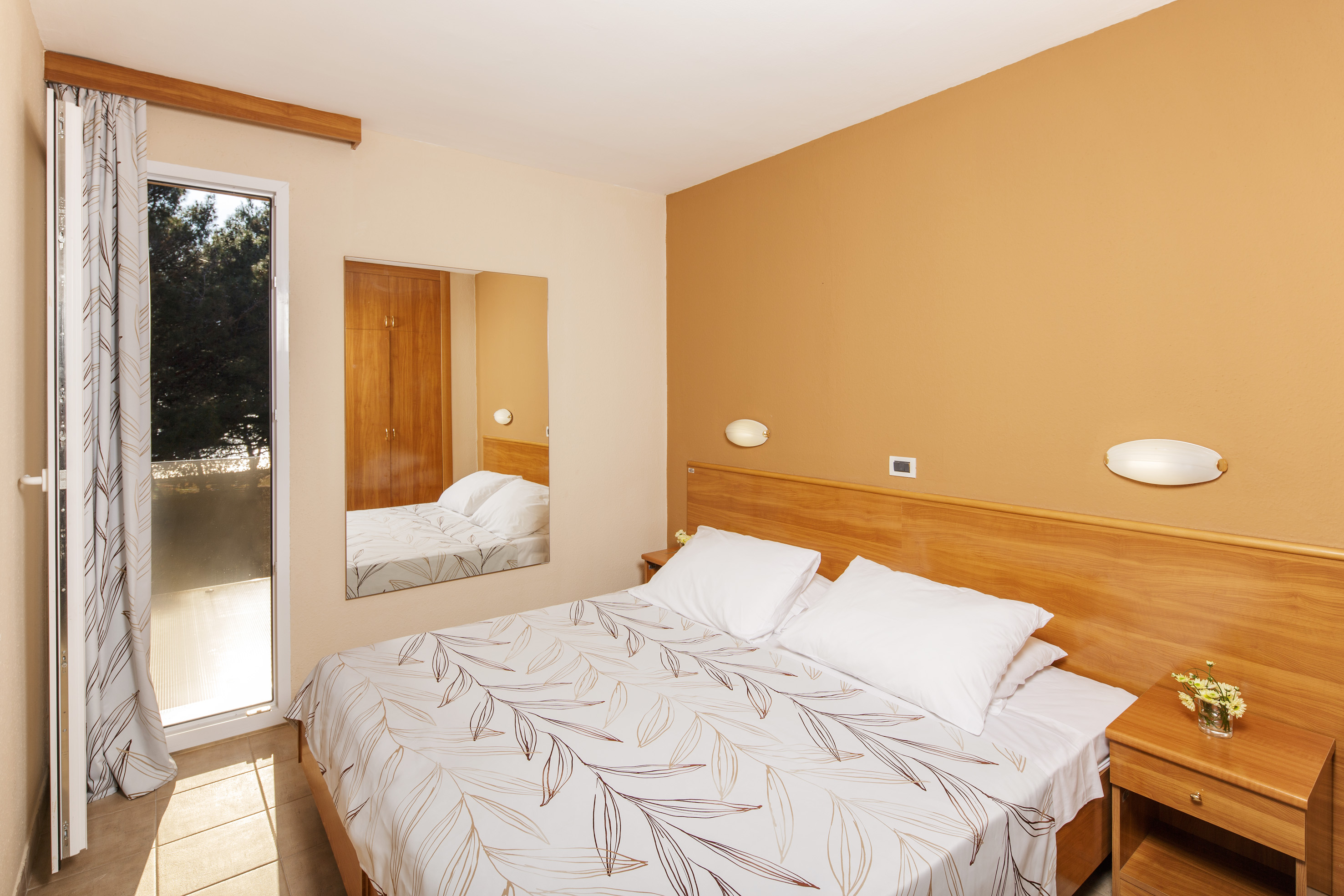 a bed with a mirror in a room