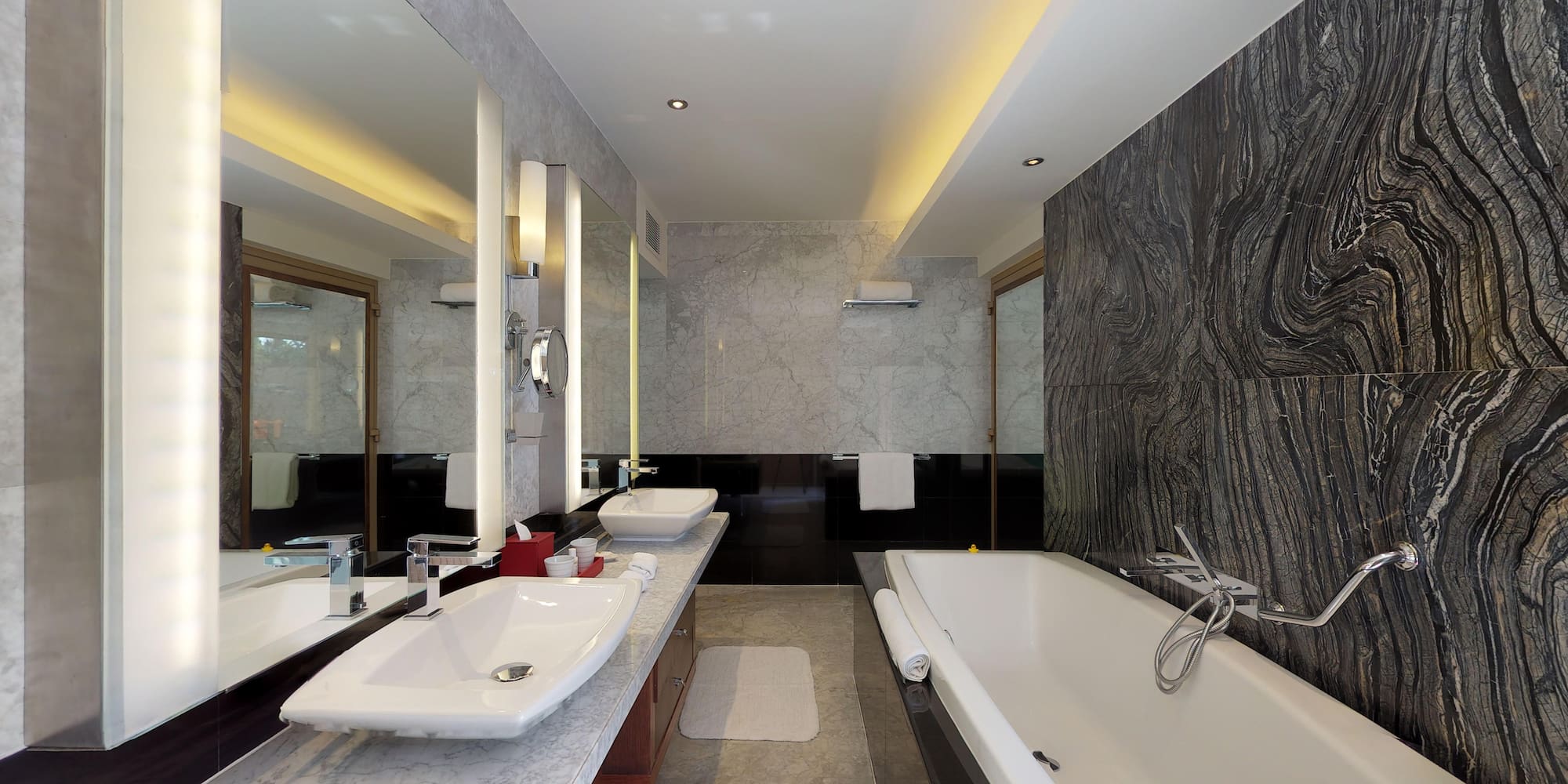 a bathroom with marble walls and a tub