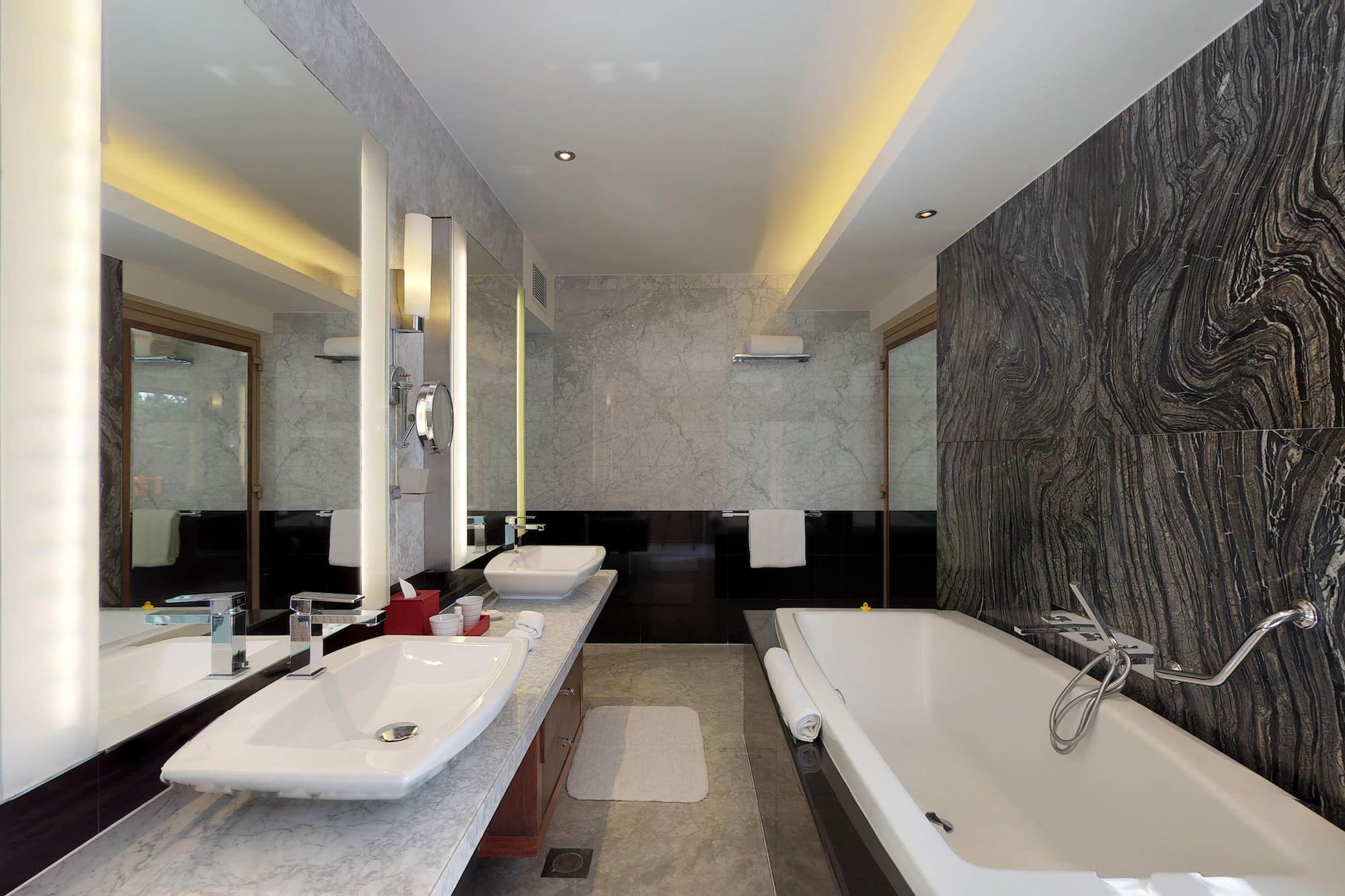 a bathroom with marble walls and a tub