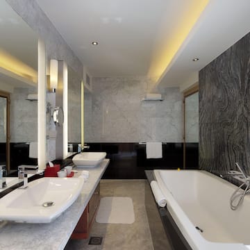 a bathroom with marble walls and a tub