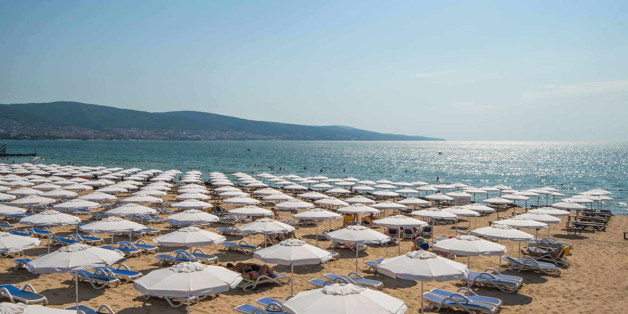 a beach with umbrellas and chairs