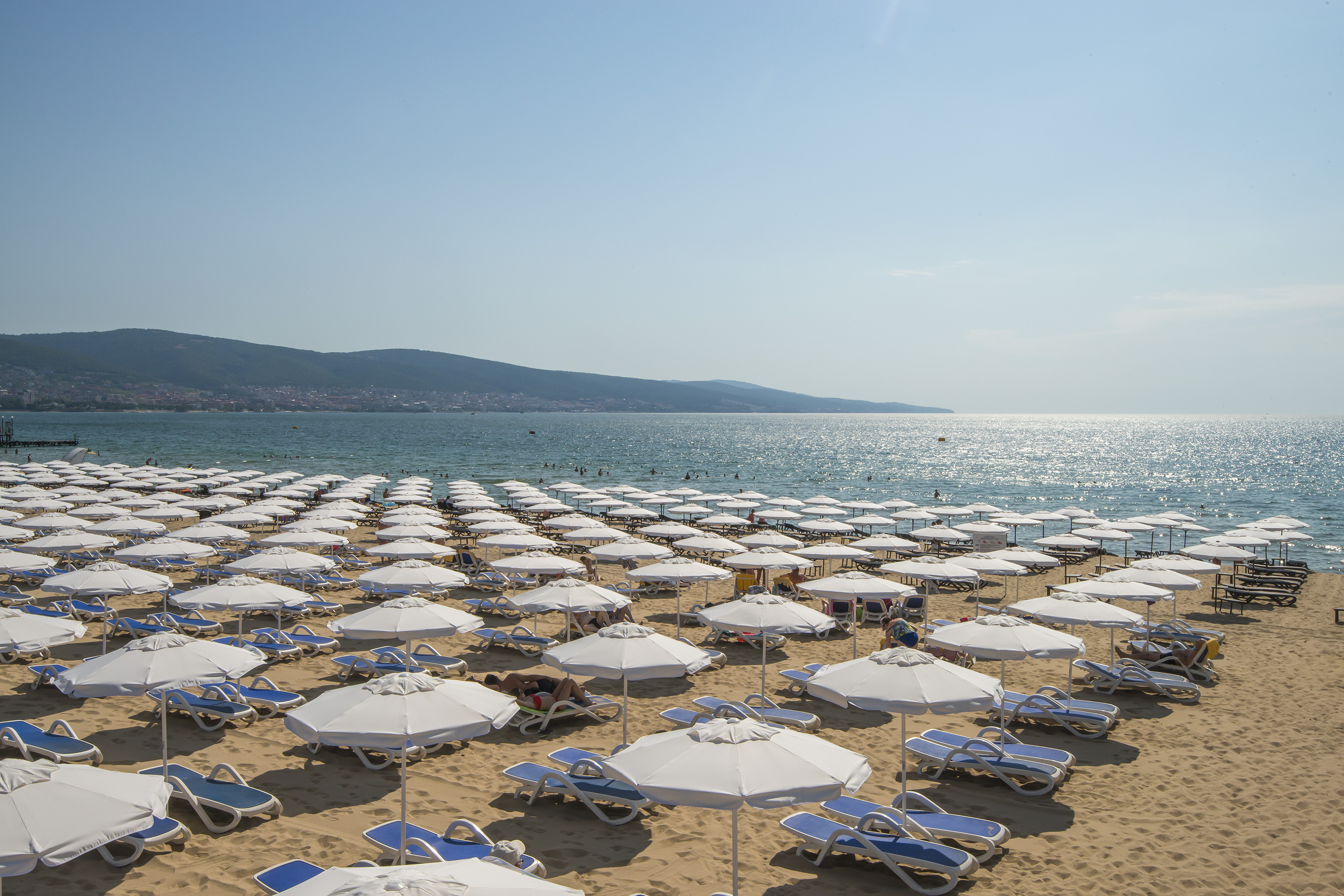 a beach with umbrellas and chairs
