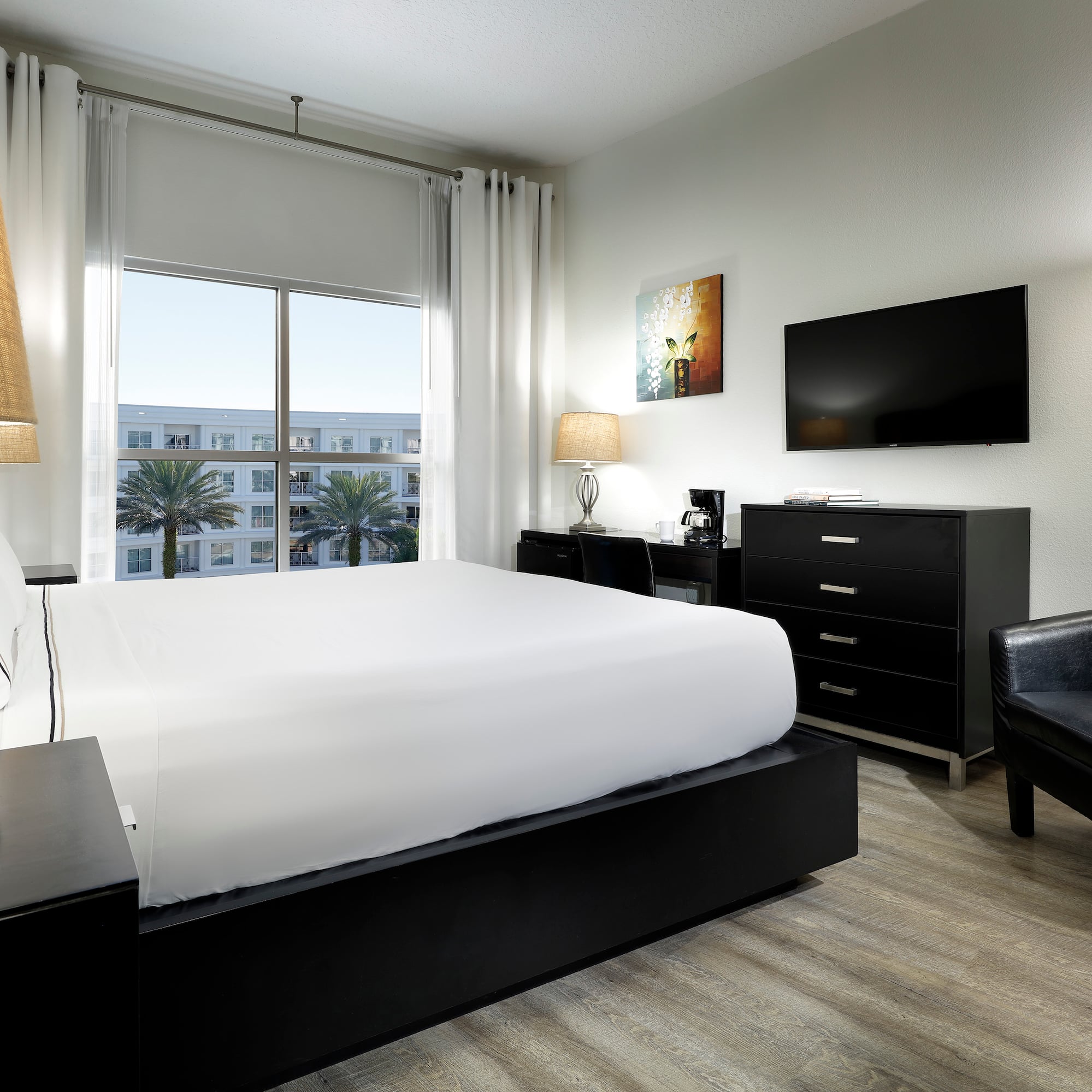 a bedroom with a bed and a television