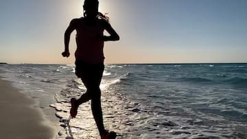 a woman running on a beach