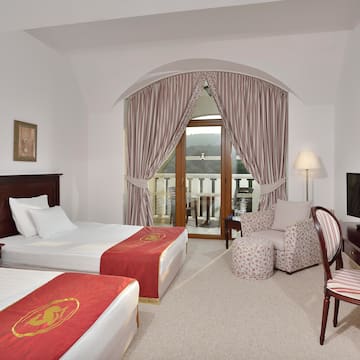 a room with two beds and a television