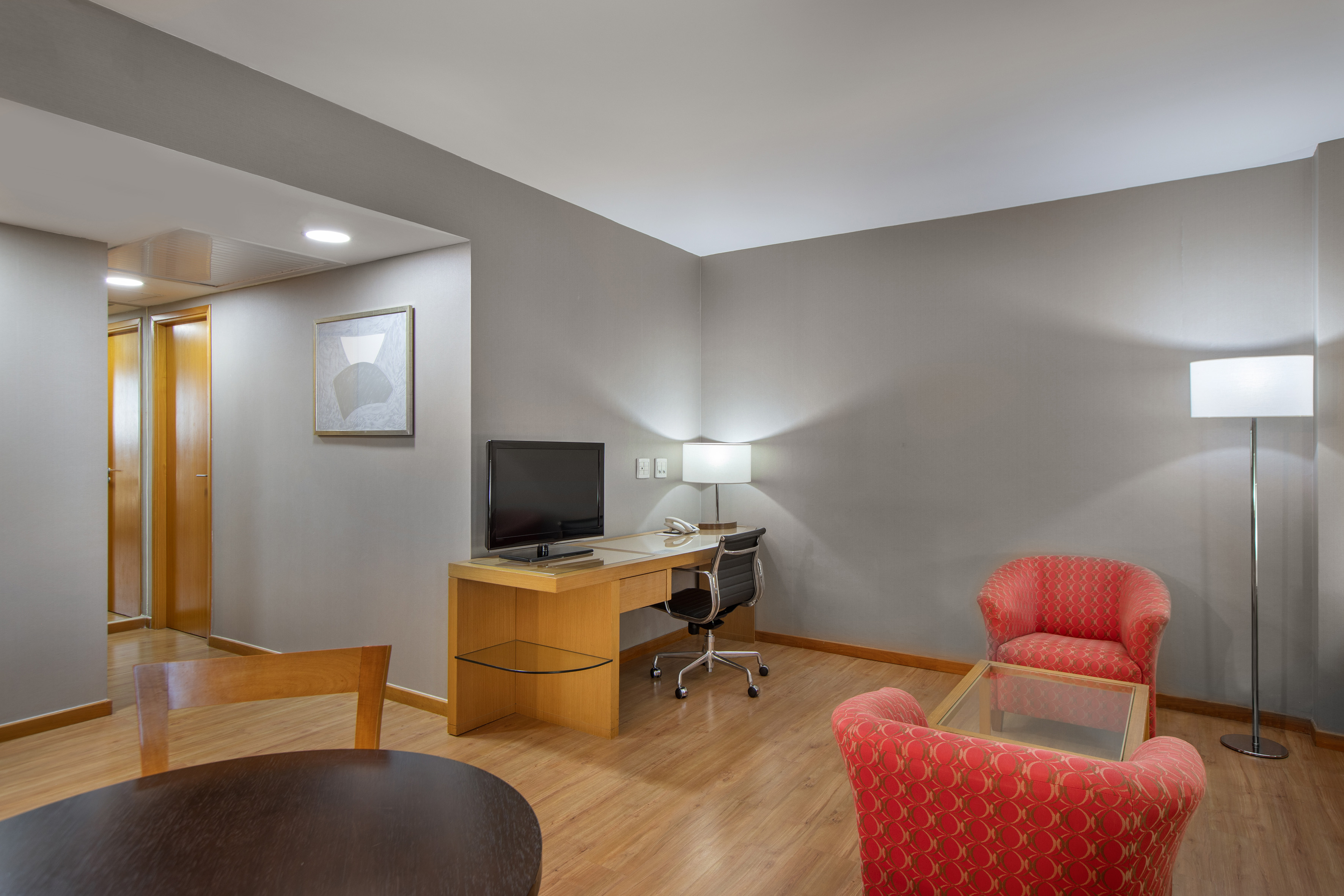 a room with a desk and chairs