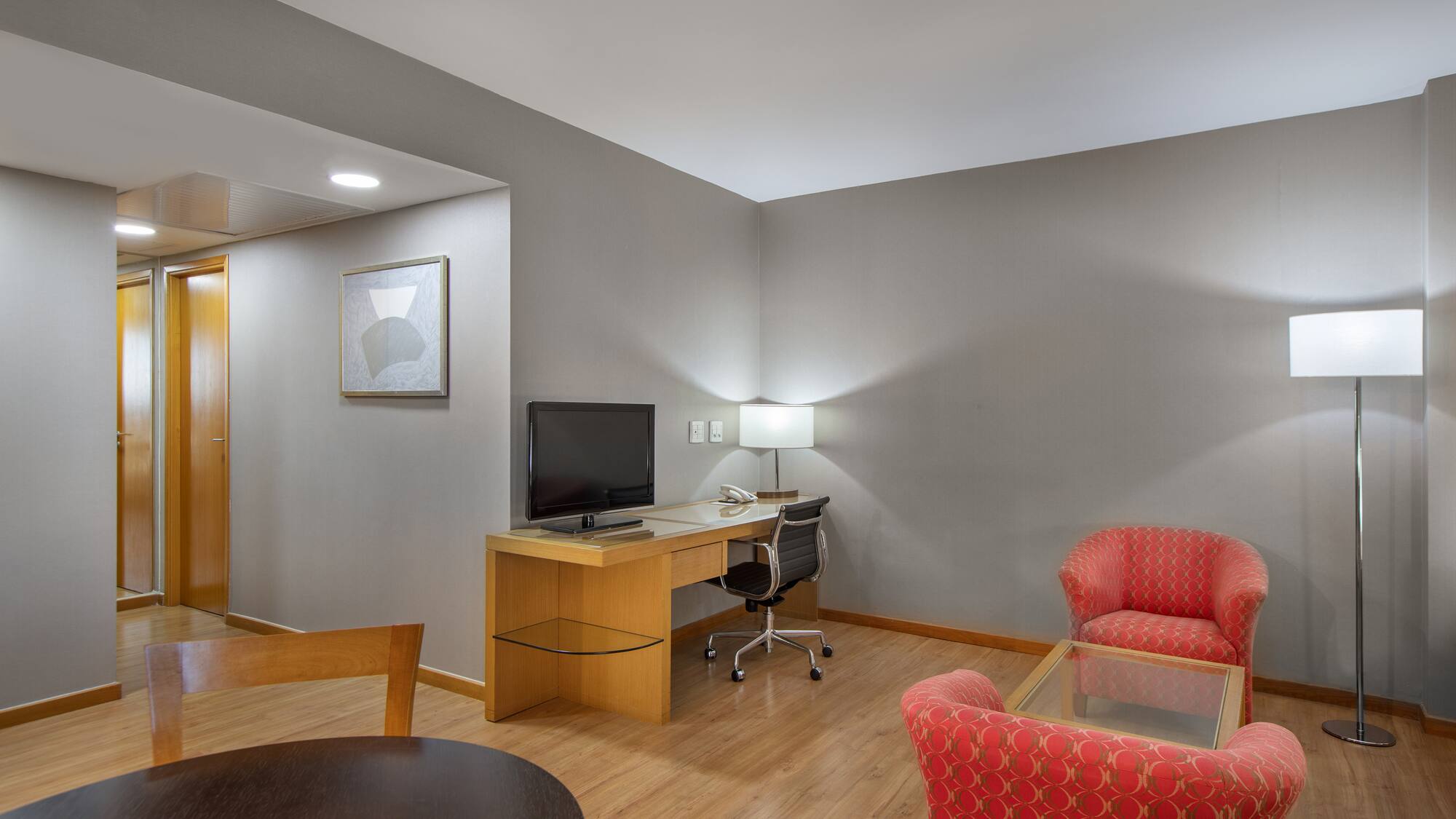 a room with a desk and chairs