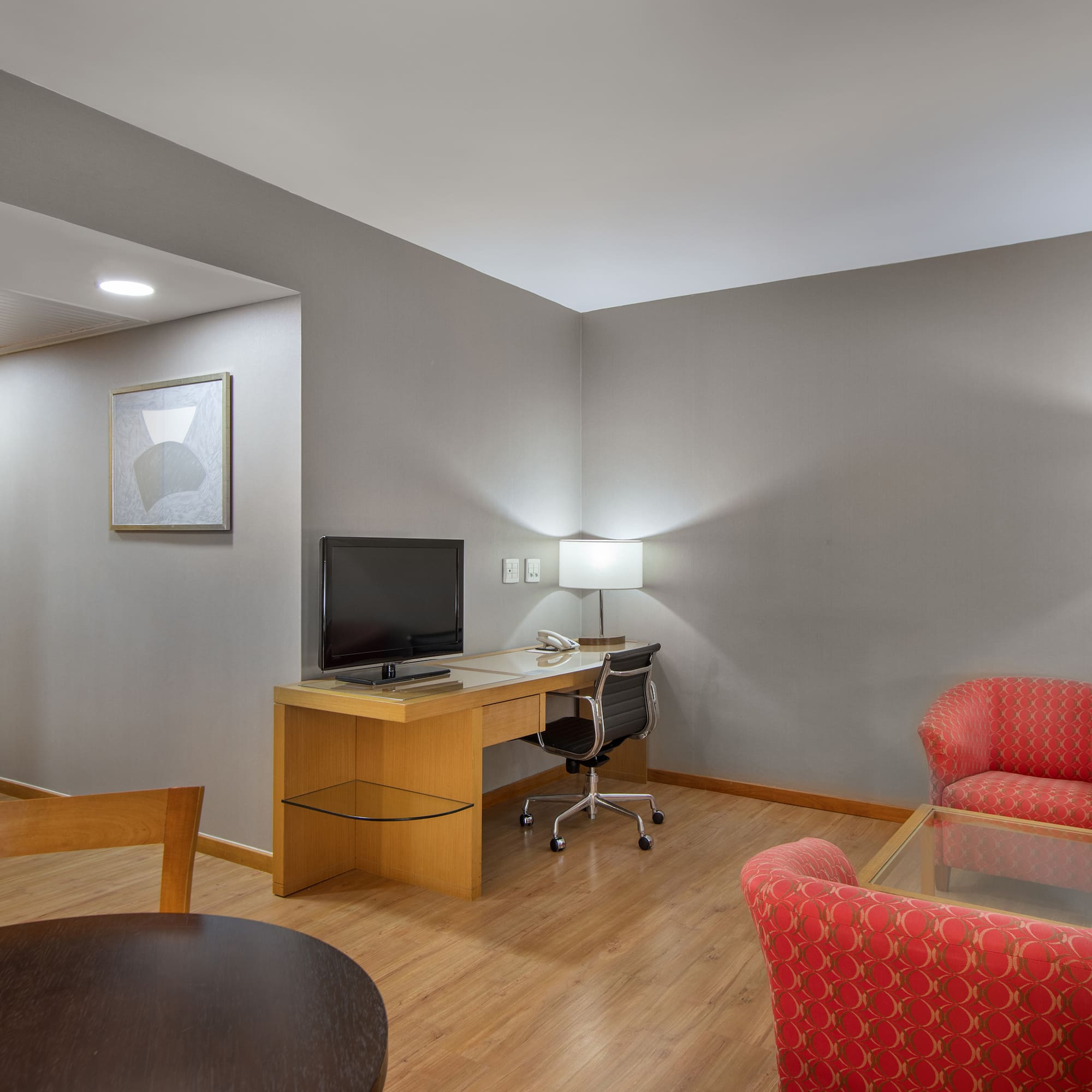 a room with a desk and chairs