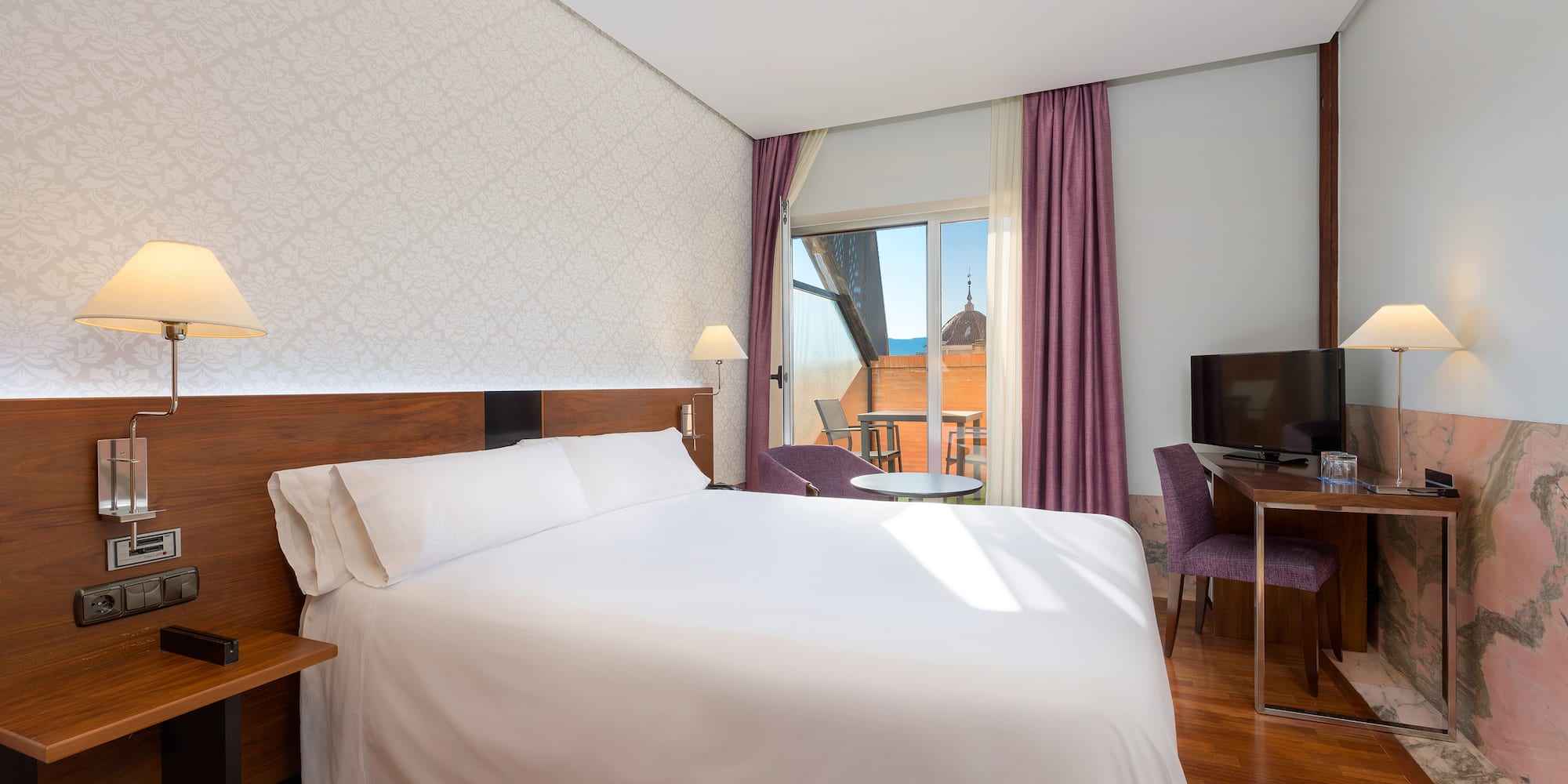 a room with a bed and a television