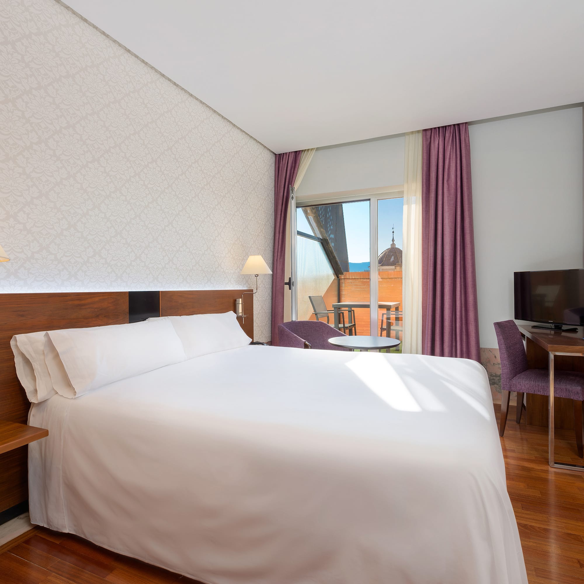 a room with a bed and a television