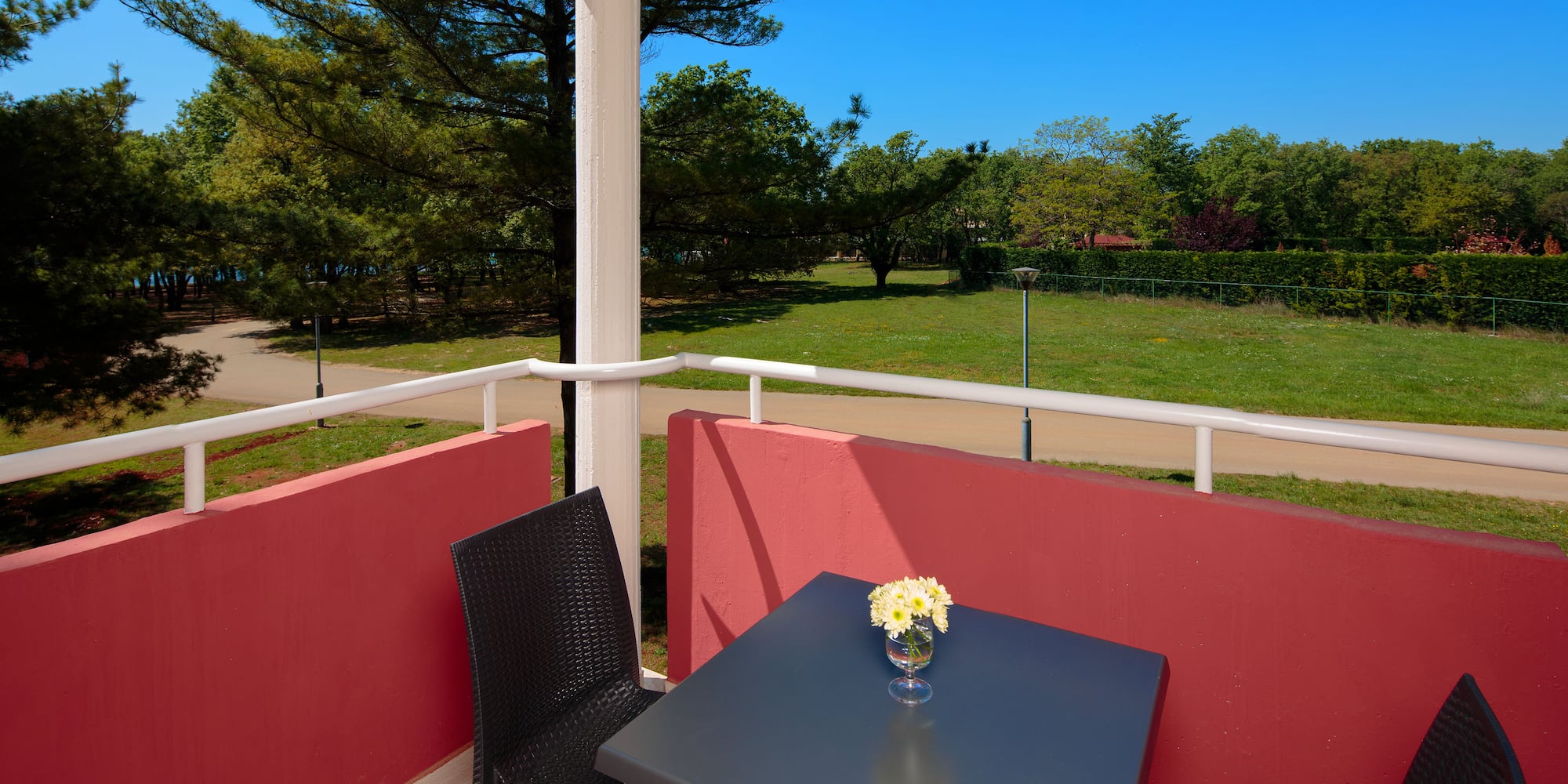 a table and chair on a balcony