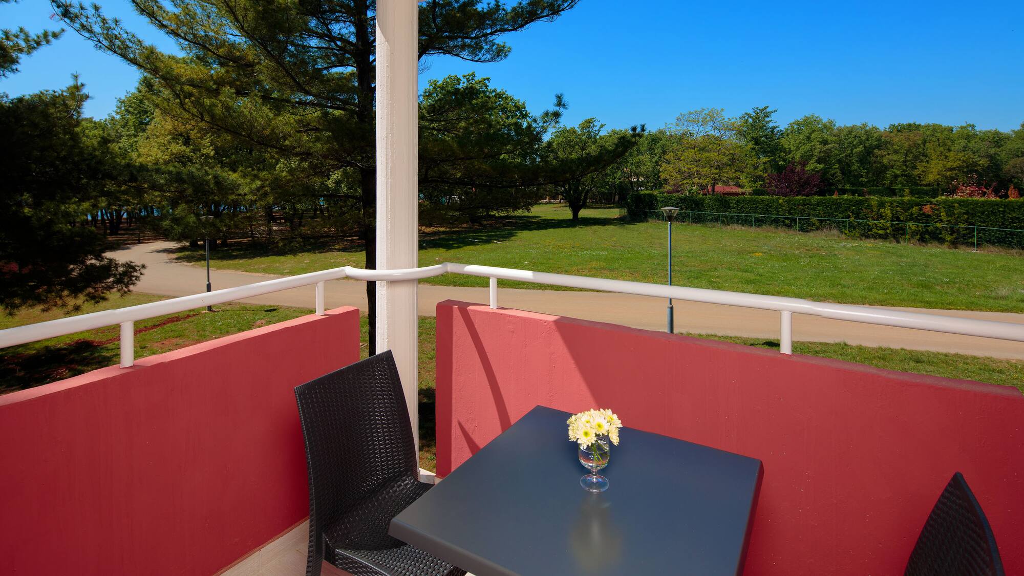 a table and chair on a balcony