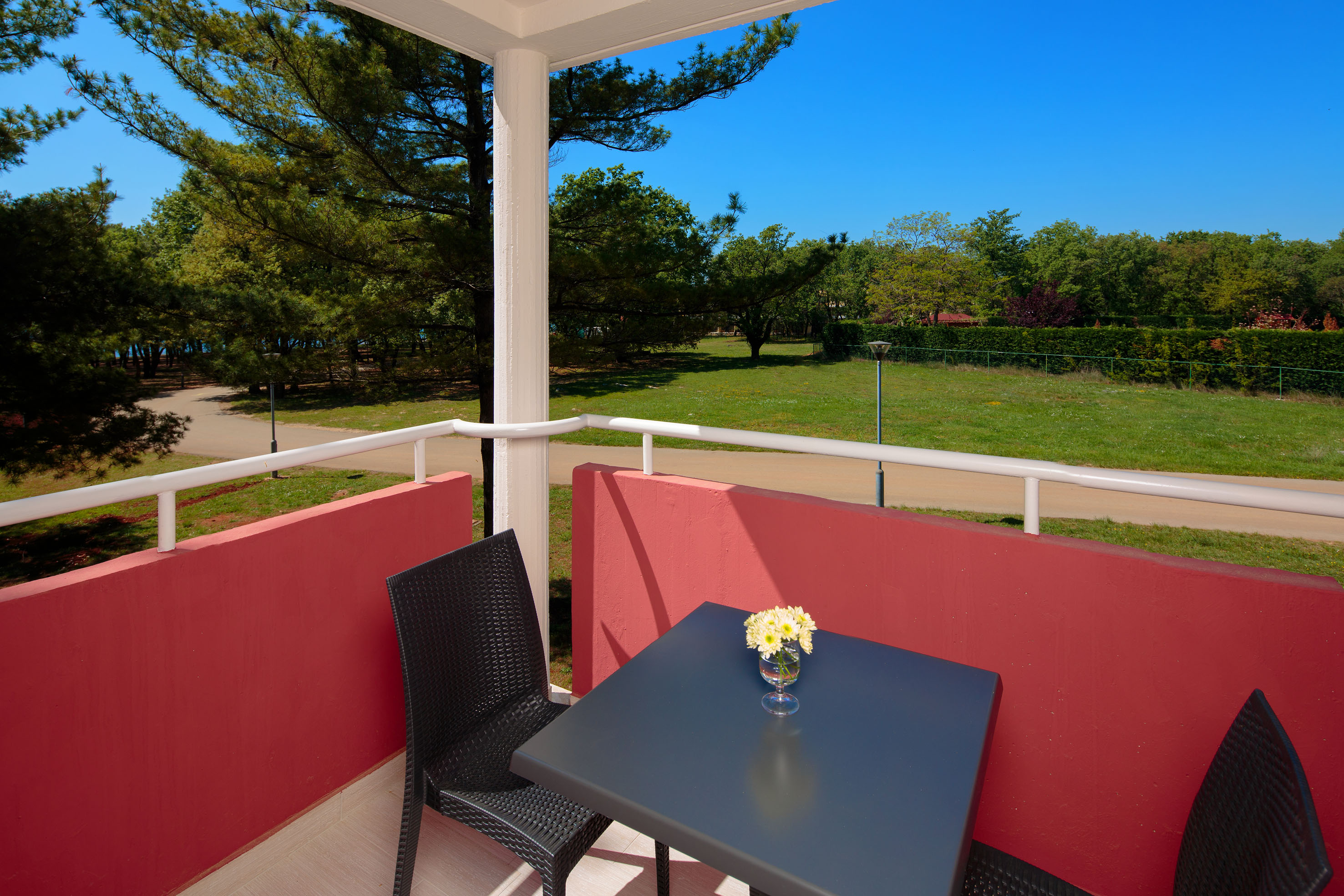a table and chair on a balcony
