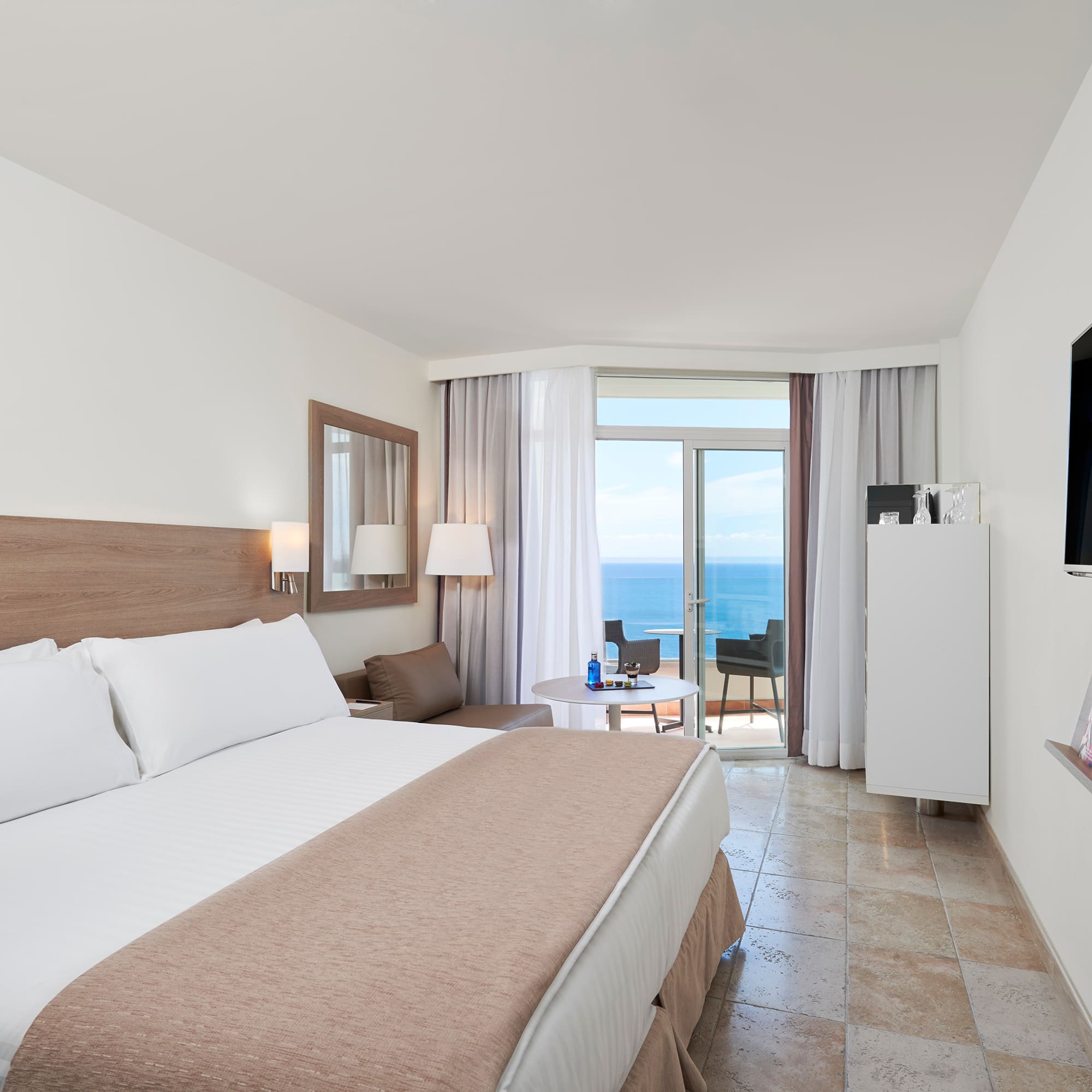 a room with a bed and a television