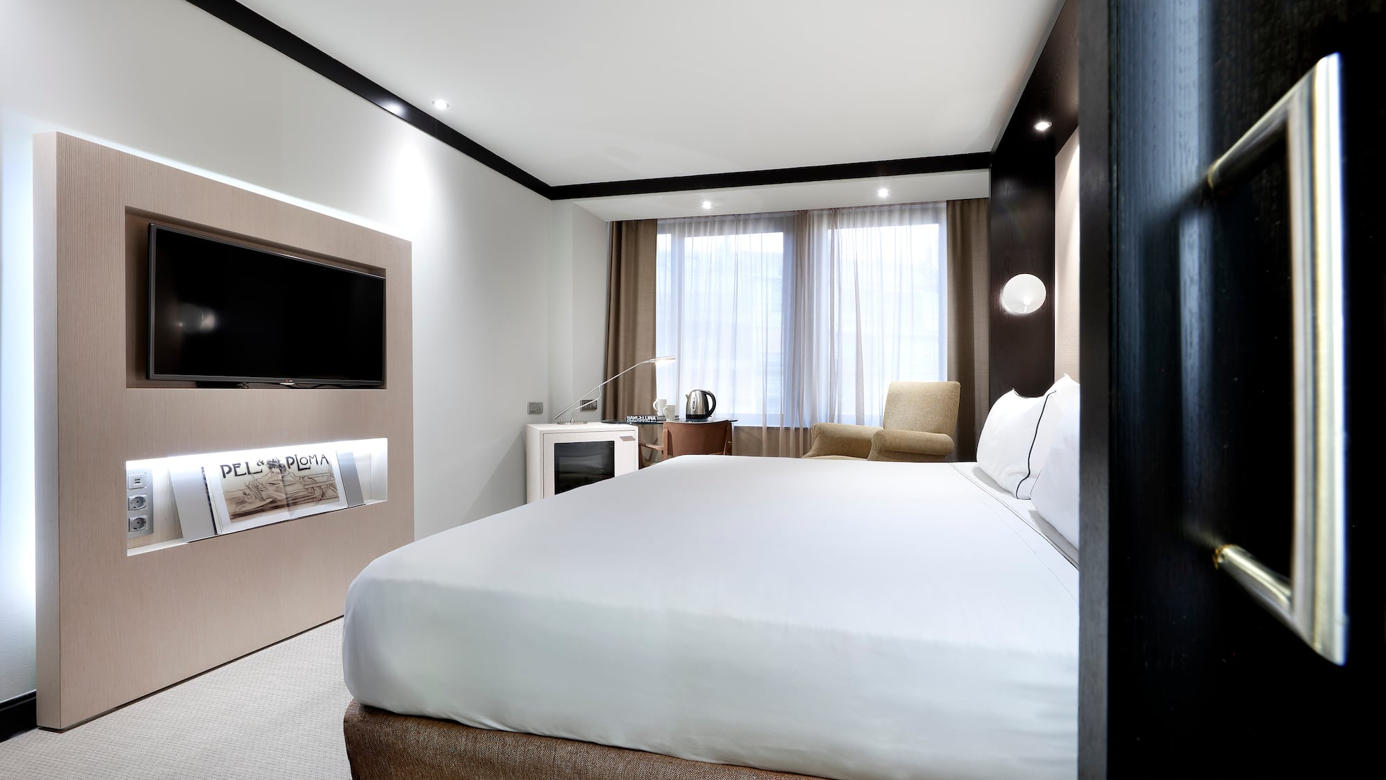 a room with a bed and a television