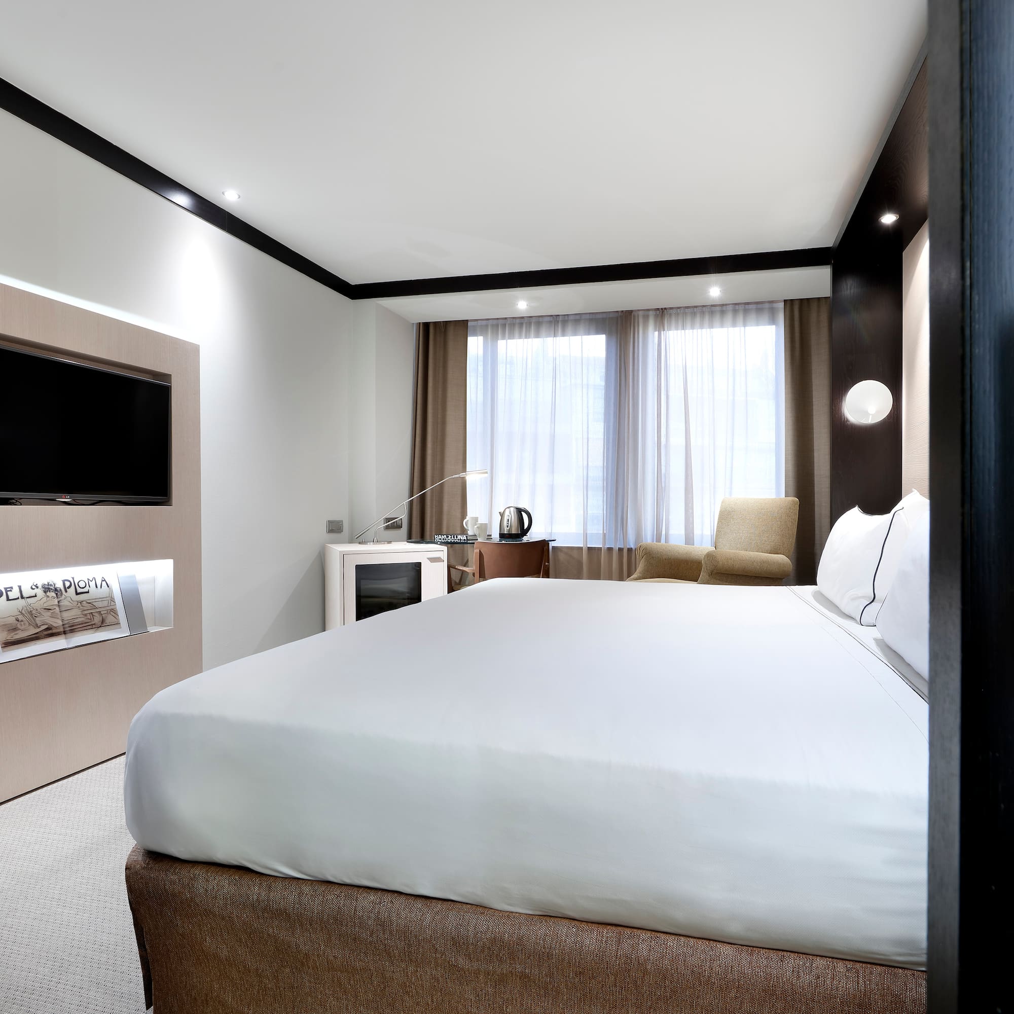 a room with a bed and a television