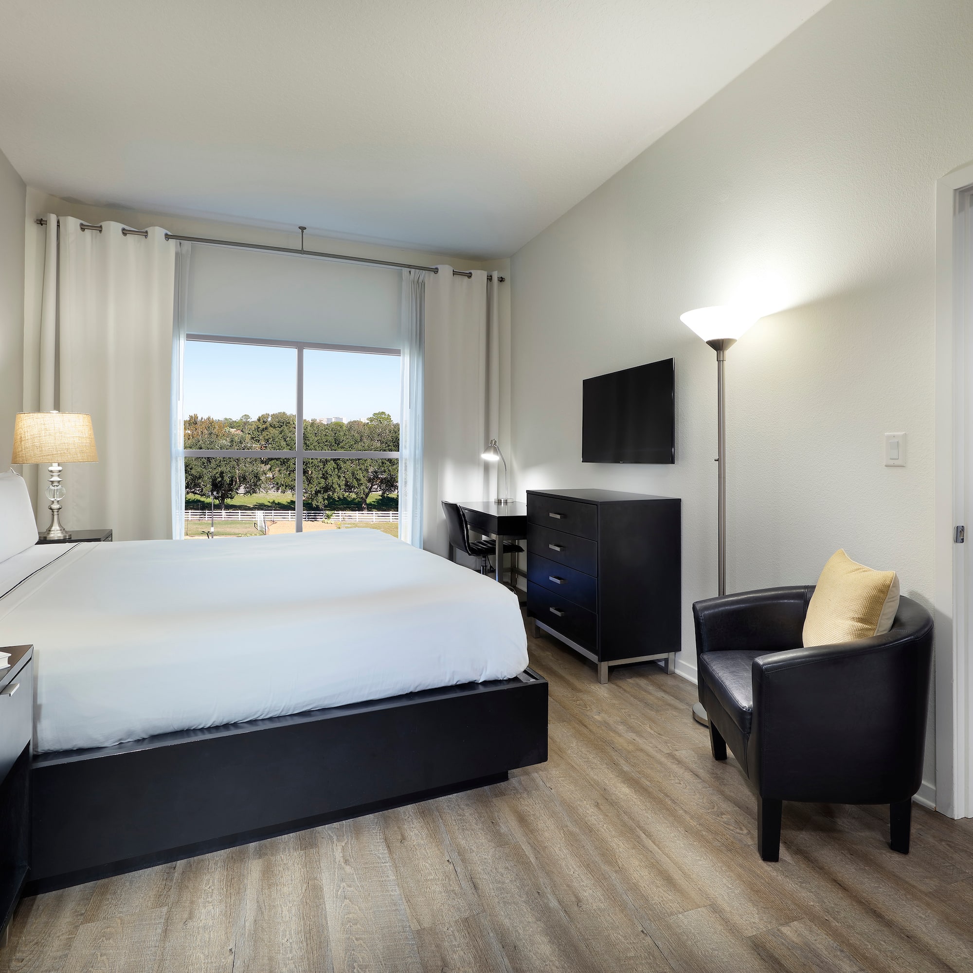 a bedroom with a bed and a chair