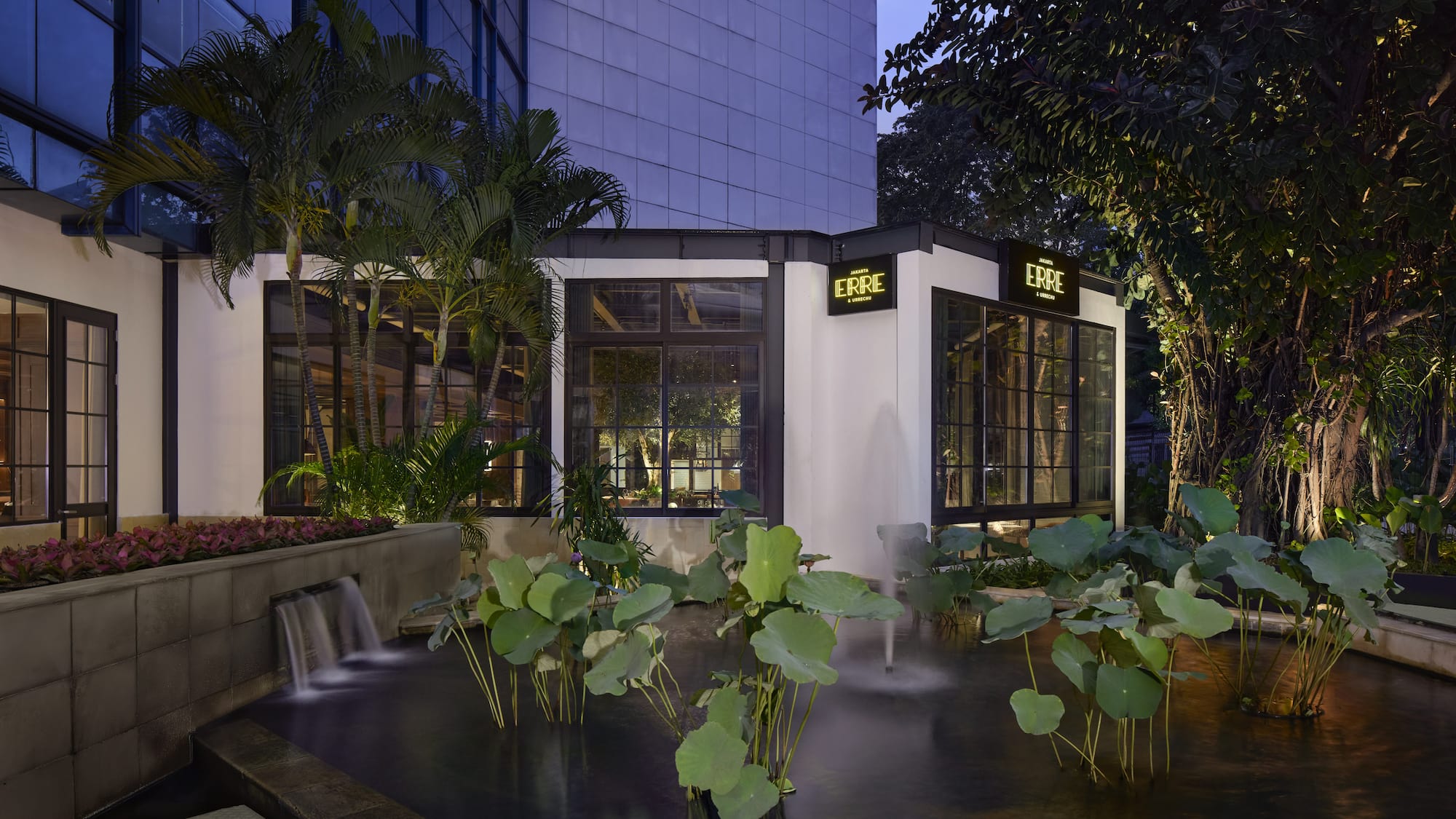 a building with a fountain and trees