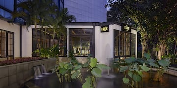 a building with a fountain and trees