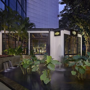 a building with a fountain and trees