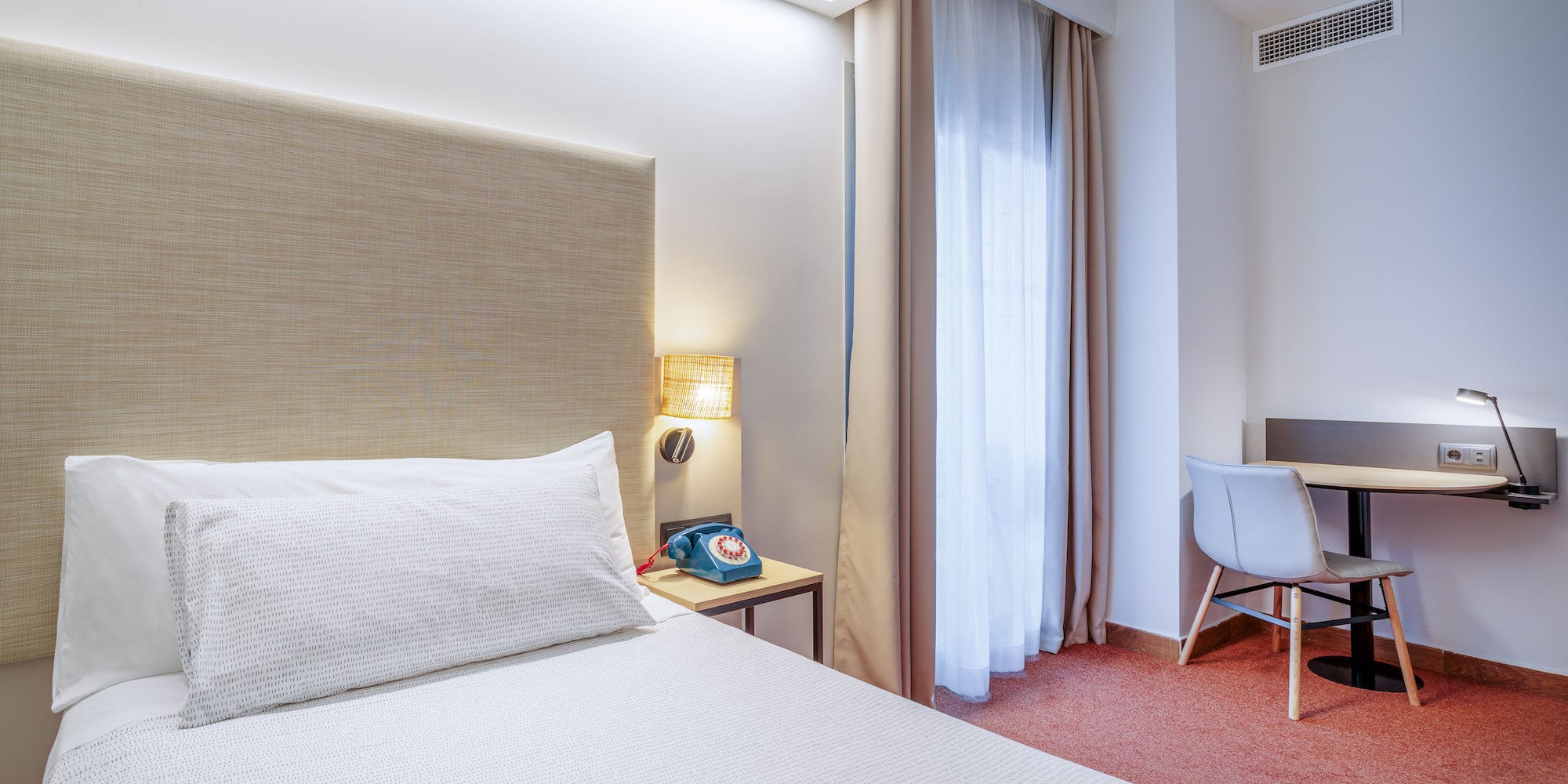 a bed with a headboard in a hotel room