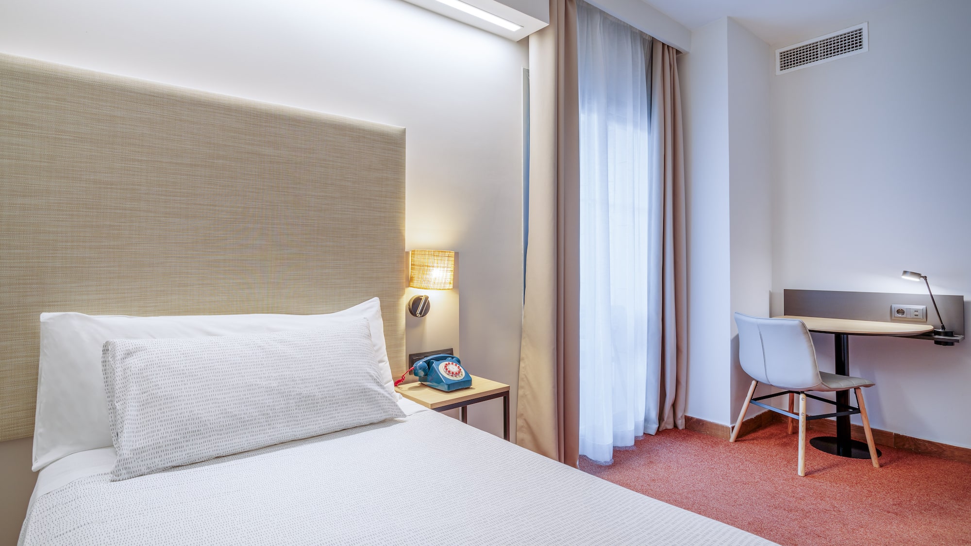 a bed with a headboard in a hotel room