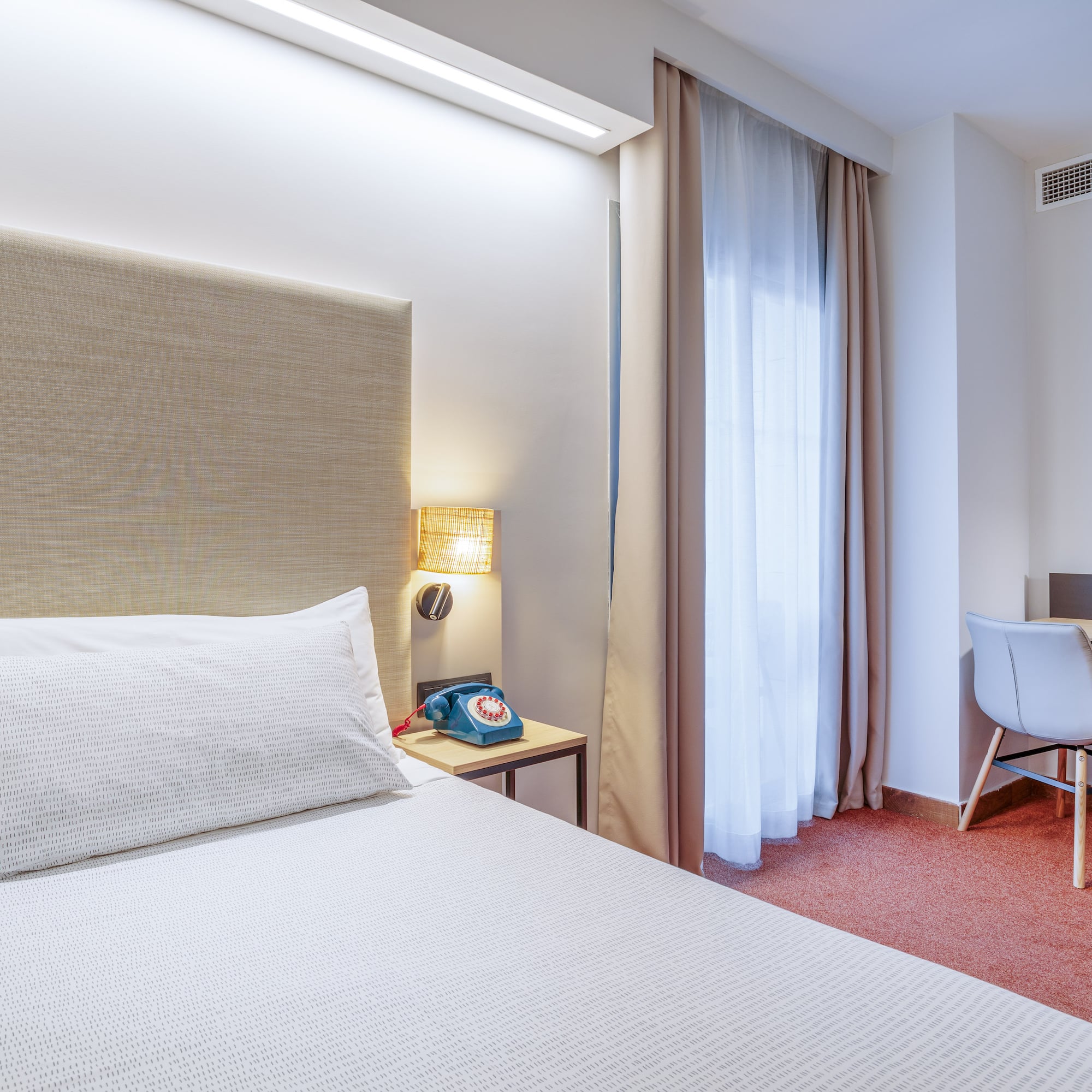 a bed with a headboard in a hotel room