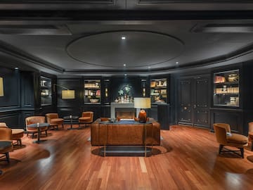 a room with a wood floor and black walls