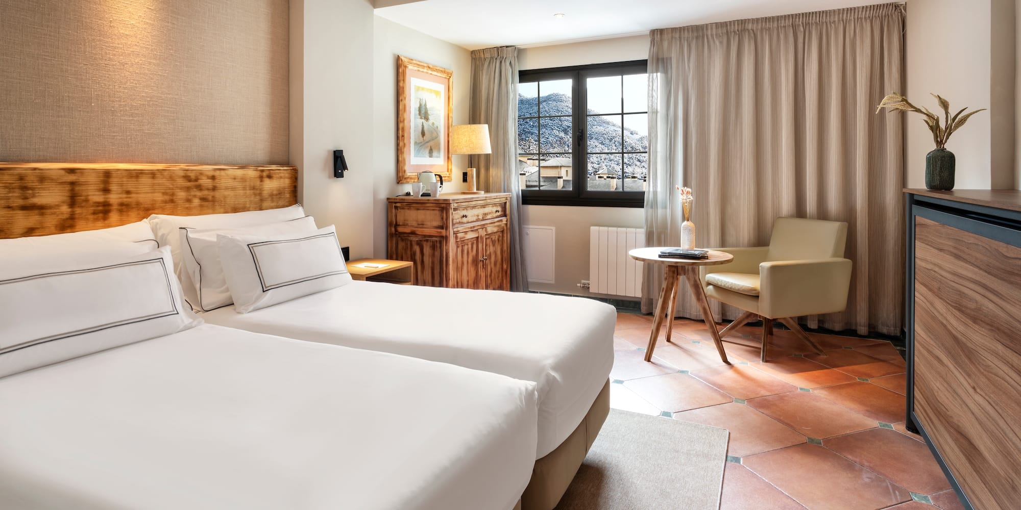a room with two beds and a chair