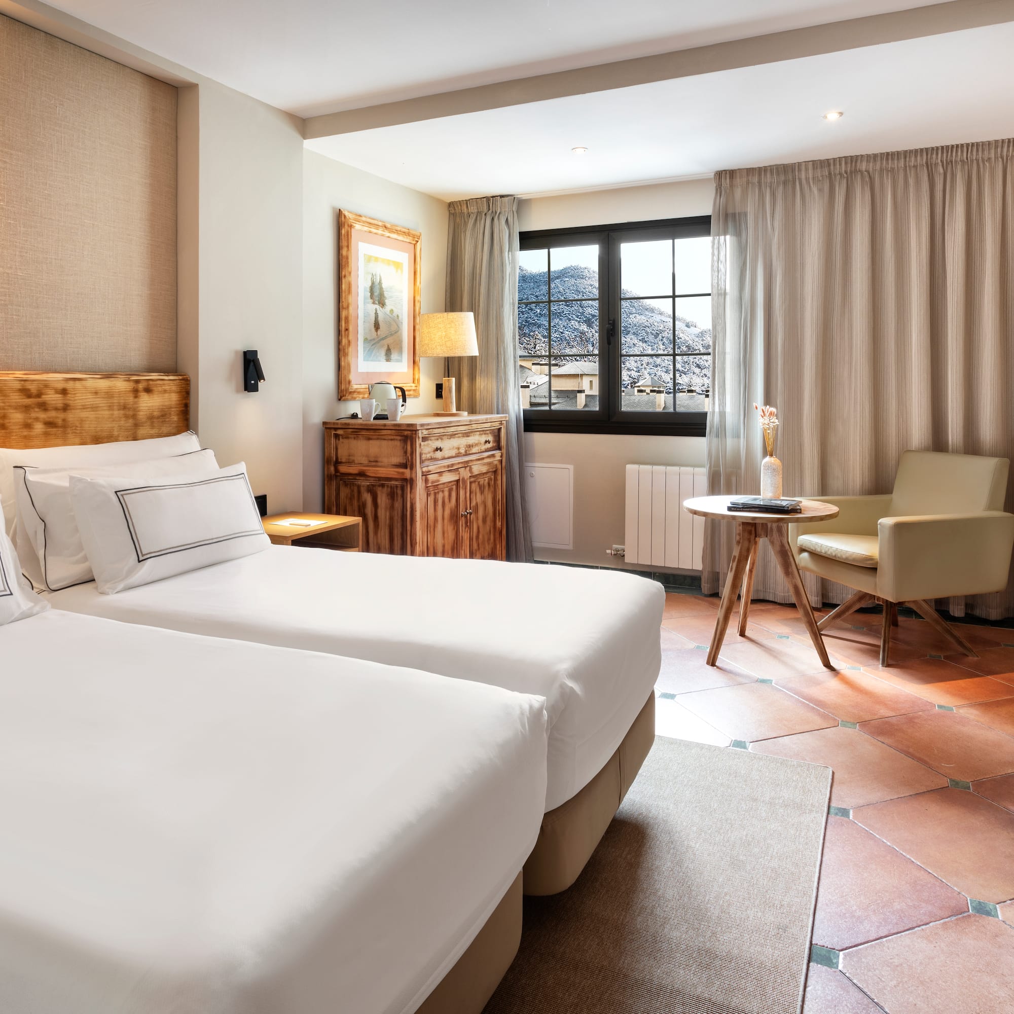 a room with two beds and a chair