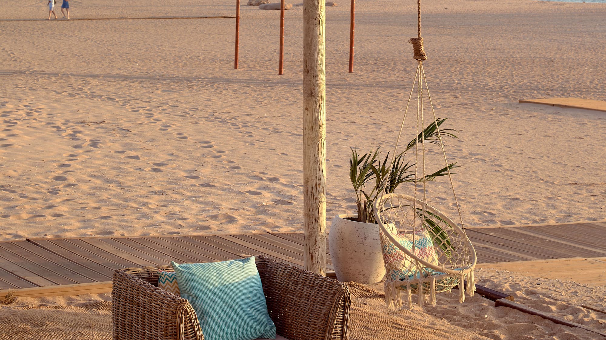 a beach with chairs and a table