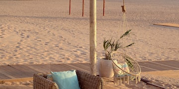 a beach with chairs and a table