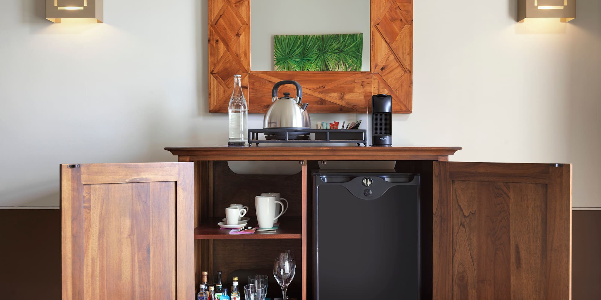 a coffee table with a tea kettle and a mirror