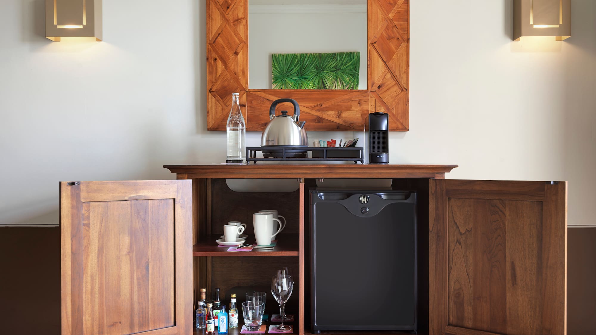 a coffee table with a tea kettle and a mirror