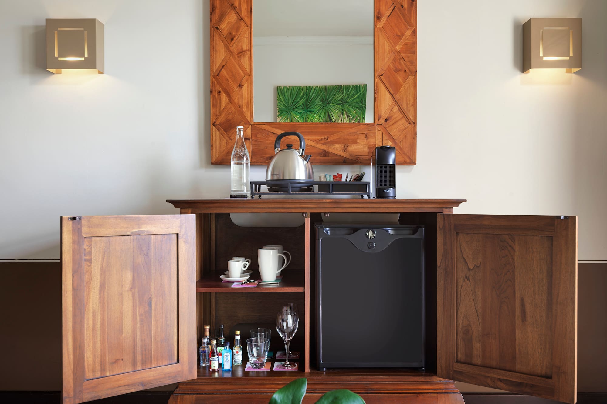 a coffee table with a tea kettle and a mirror