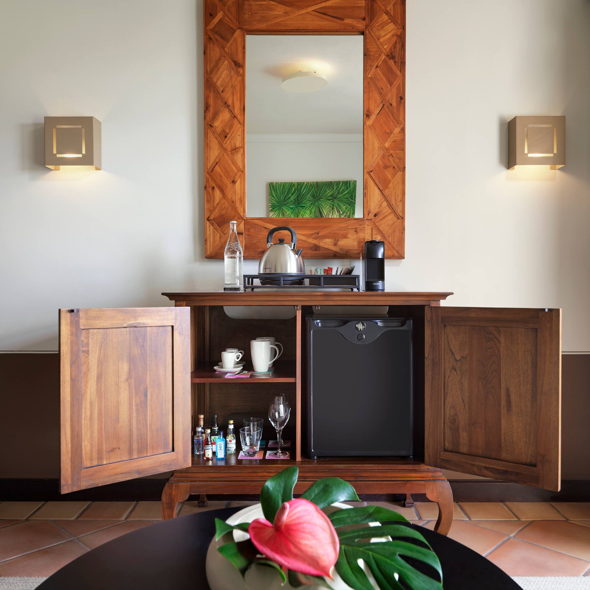a coffee table with a tea kettle and a mirror