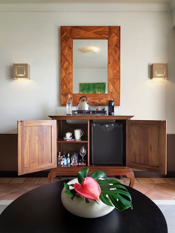 a coffee table with a tea kettle and a mirror