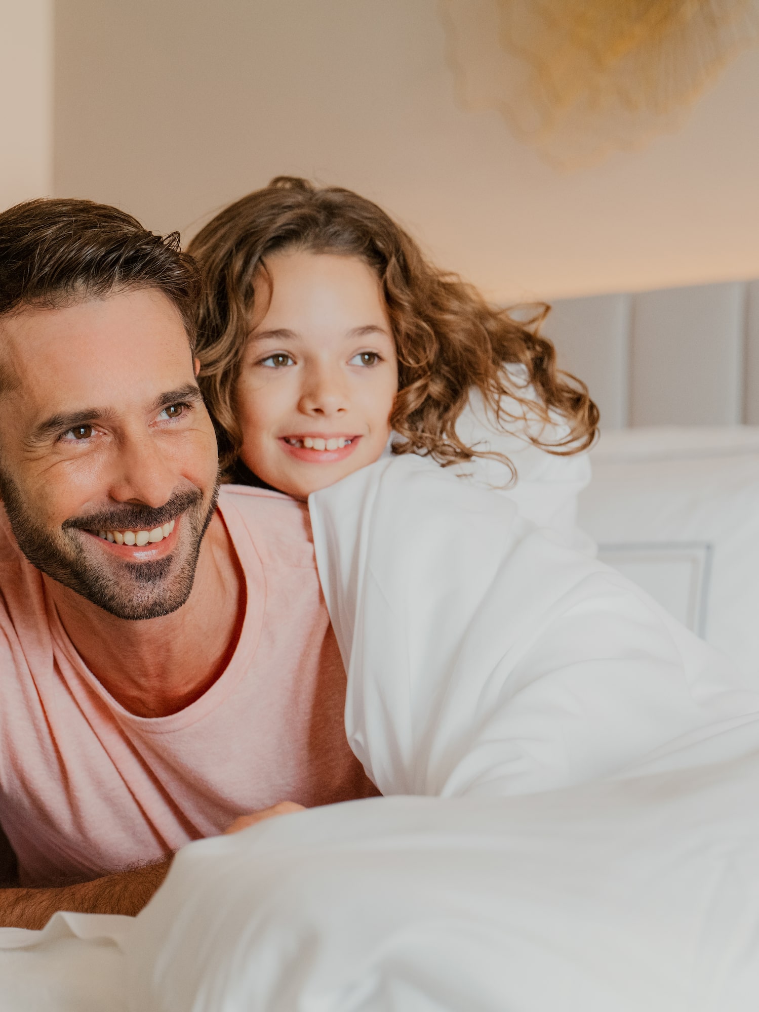 a man and a child lying on a bed