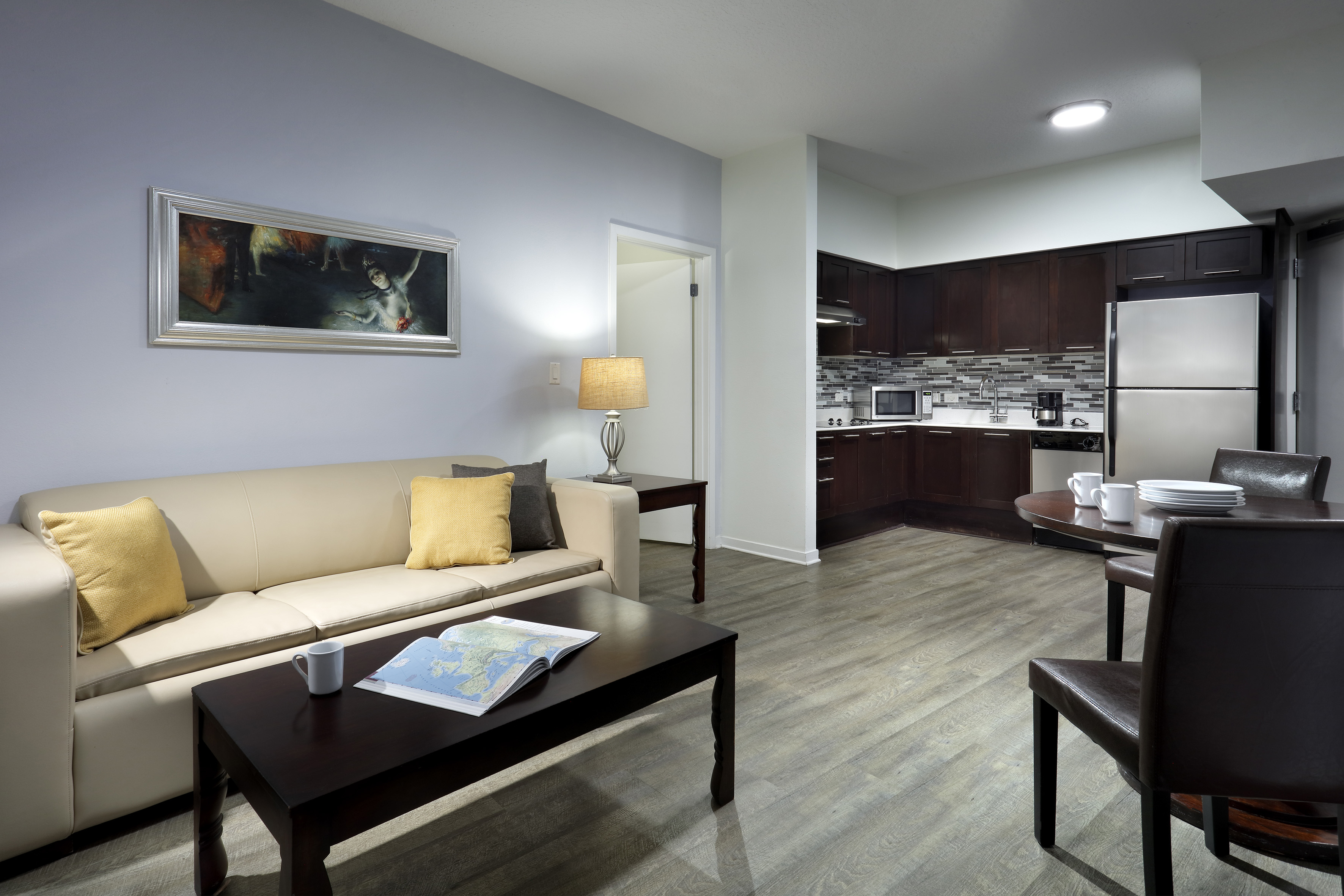 Modern open-concept apartment with living room, kitchen, and dining area.