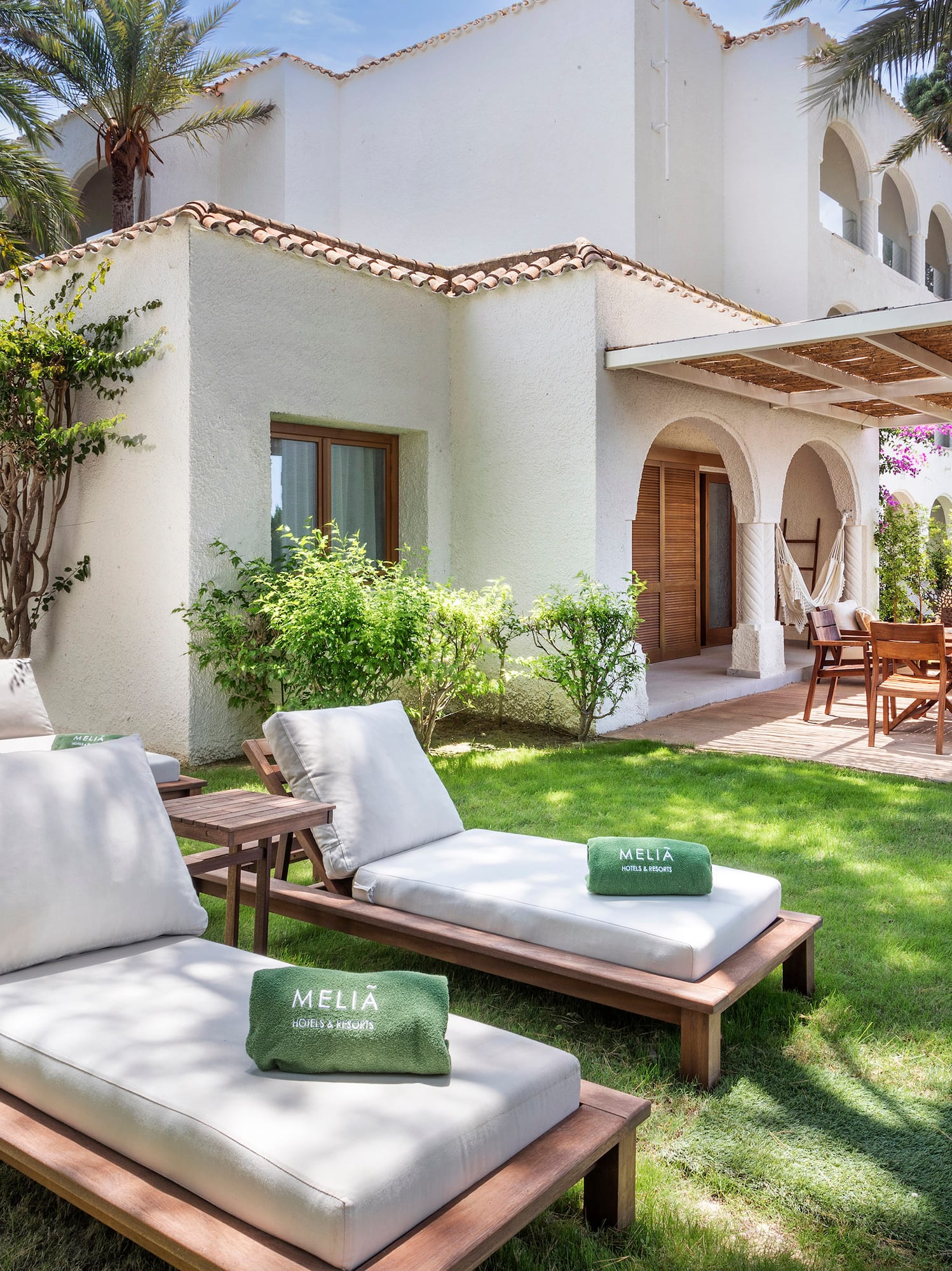 a lawn chairs and a patio in a backyard