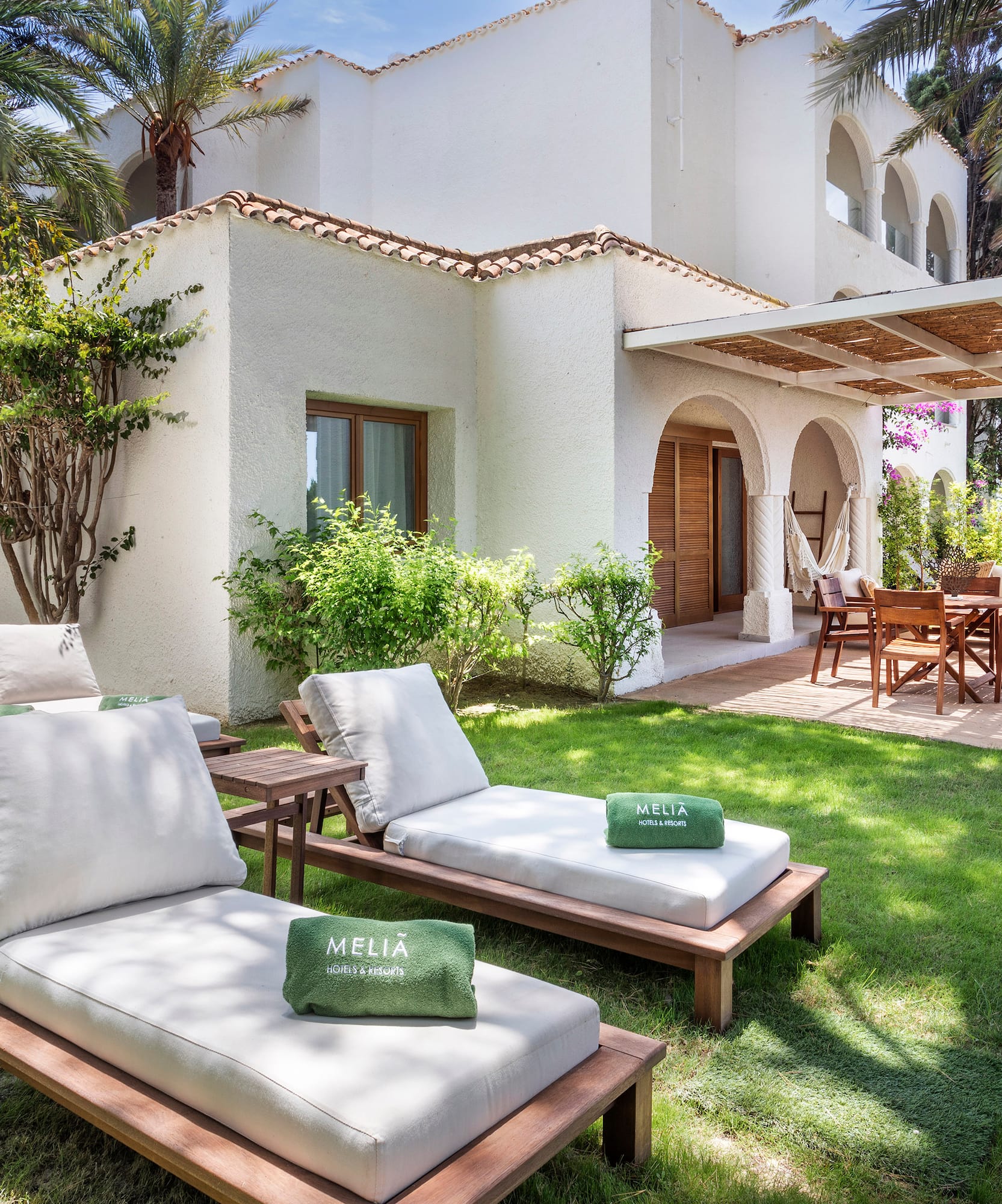 a lawn chairs and a patio in a backyard