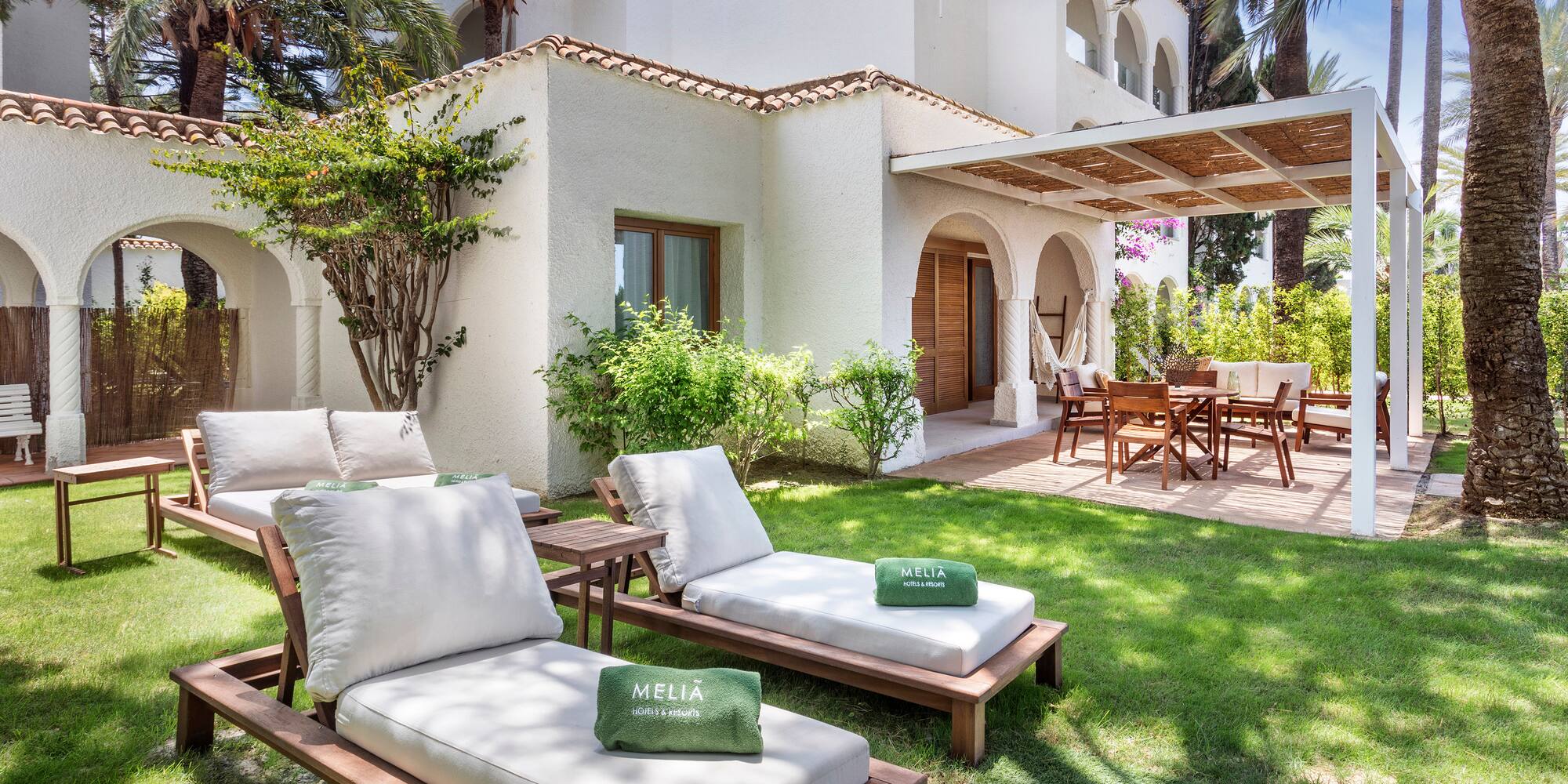 a lawn chairs and a patio in a backyard