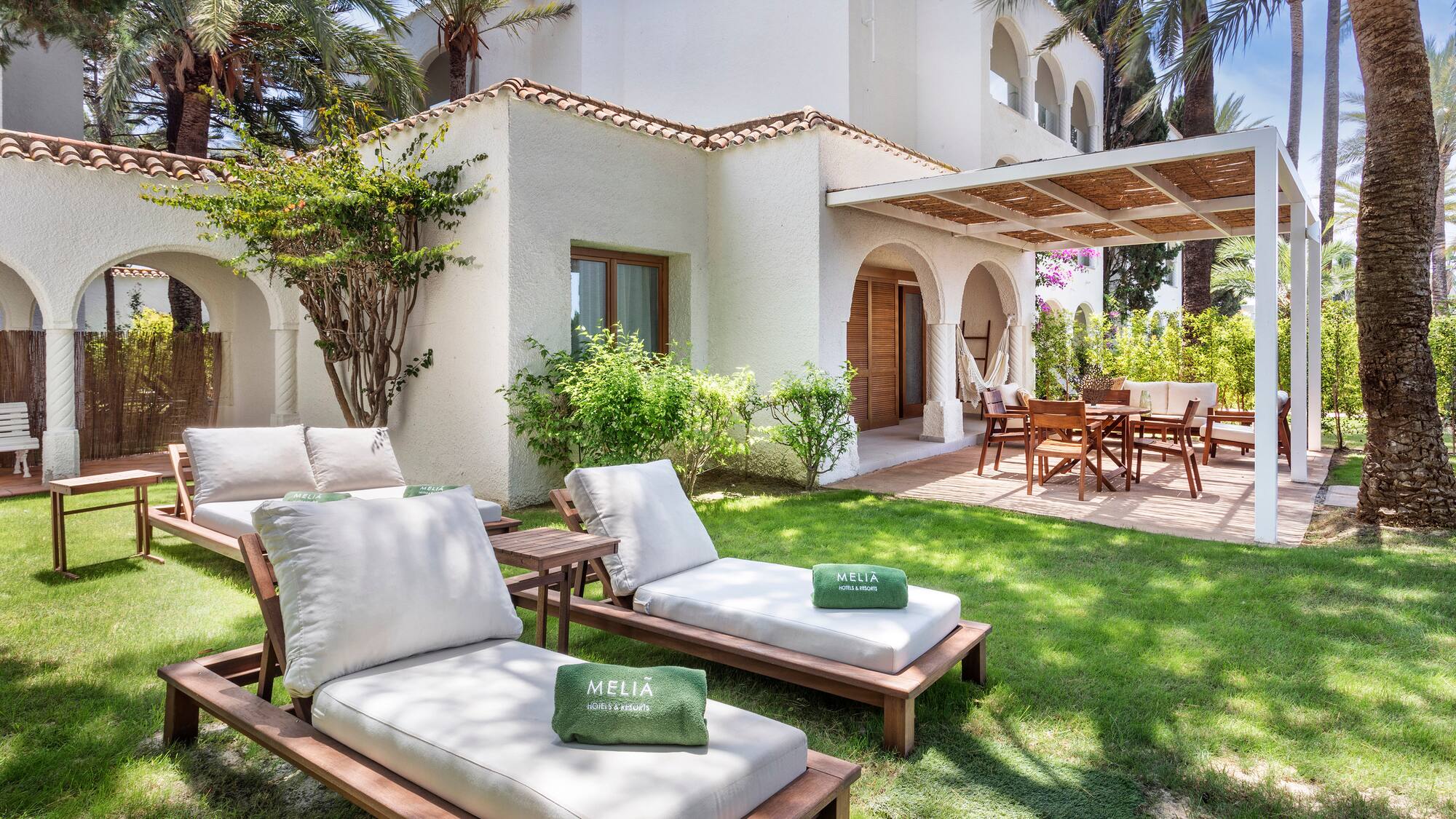 a lawn chairs and a patio in a backyard