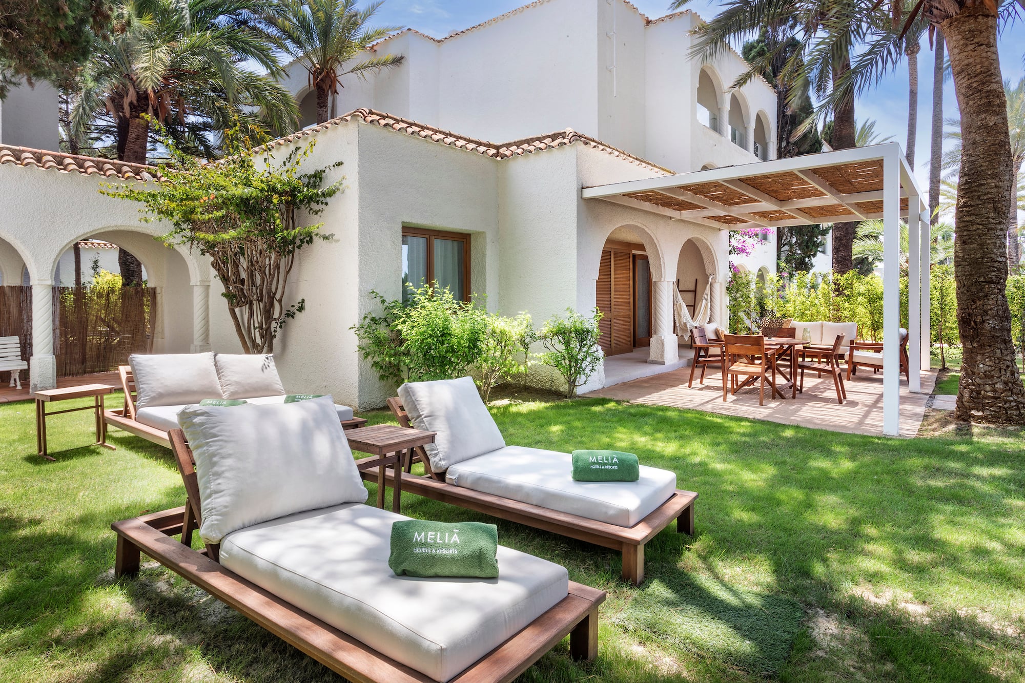 a lawn chairs and a patio in a backyard