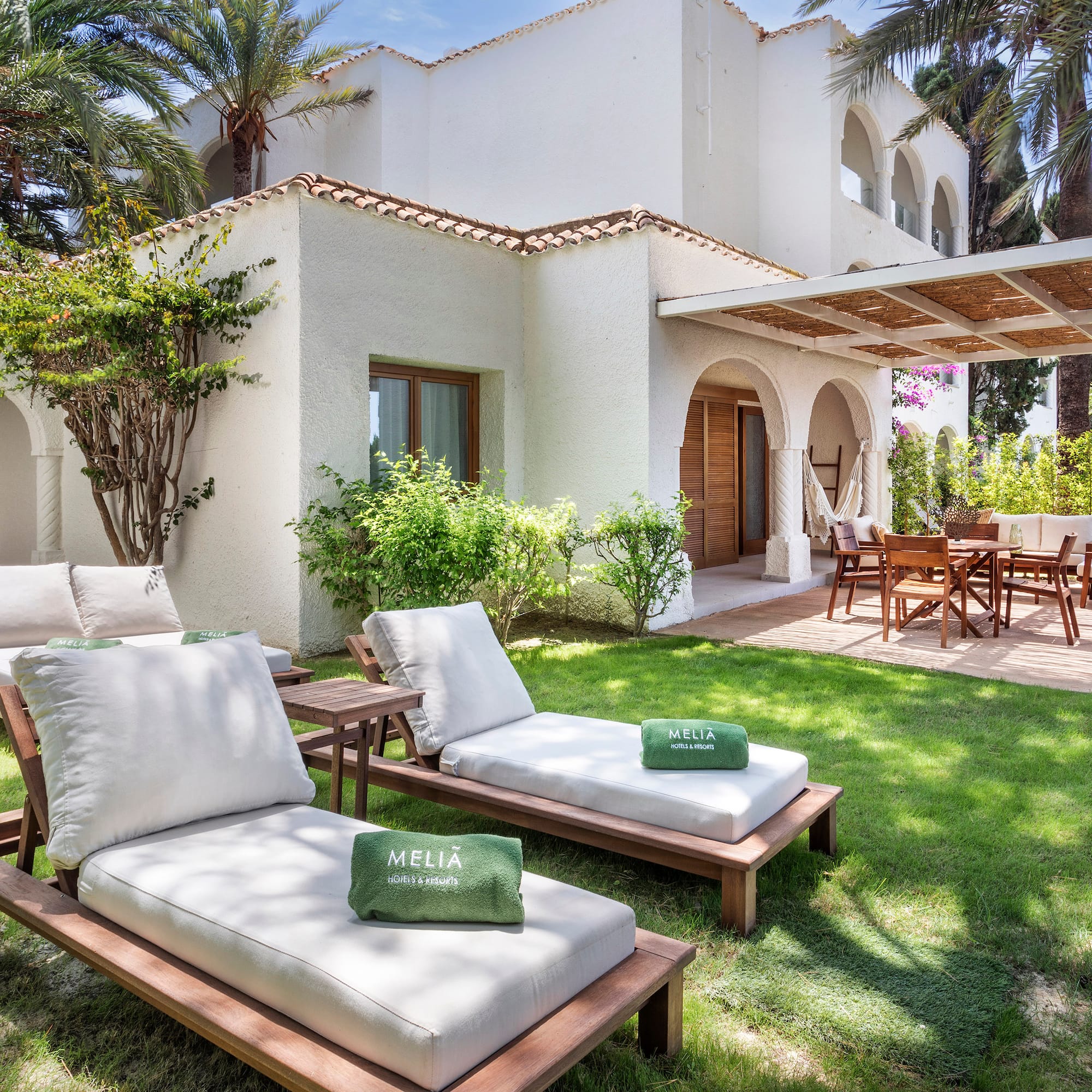 a lawn chairs and a patio in a backyard