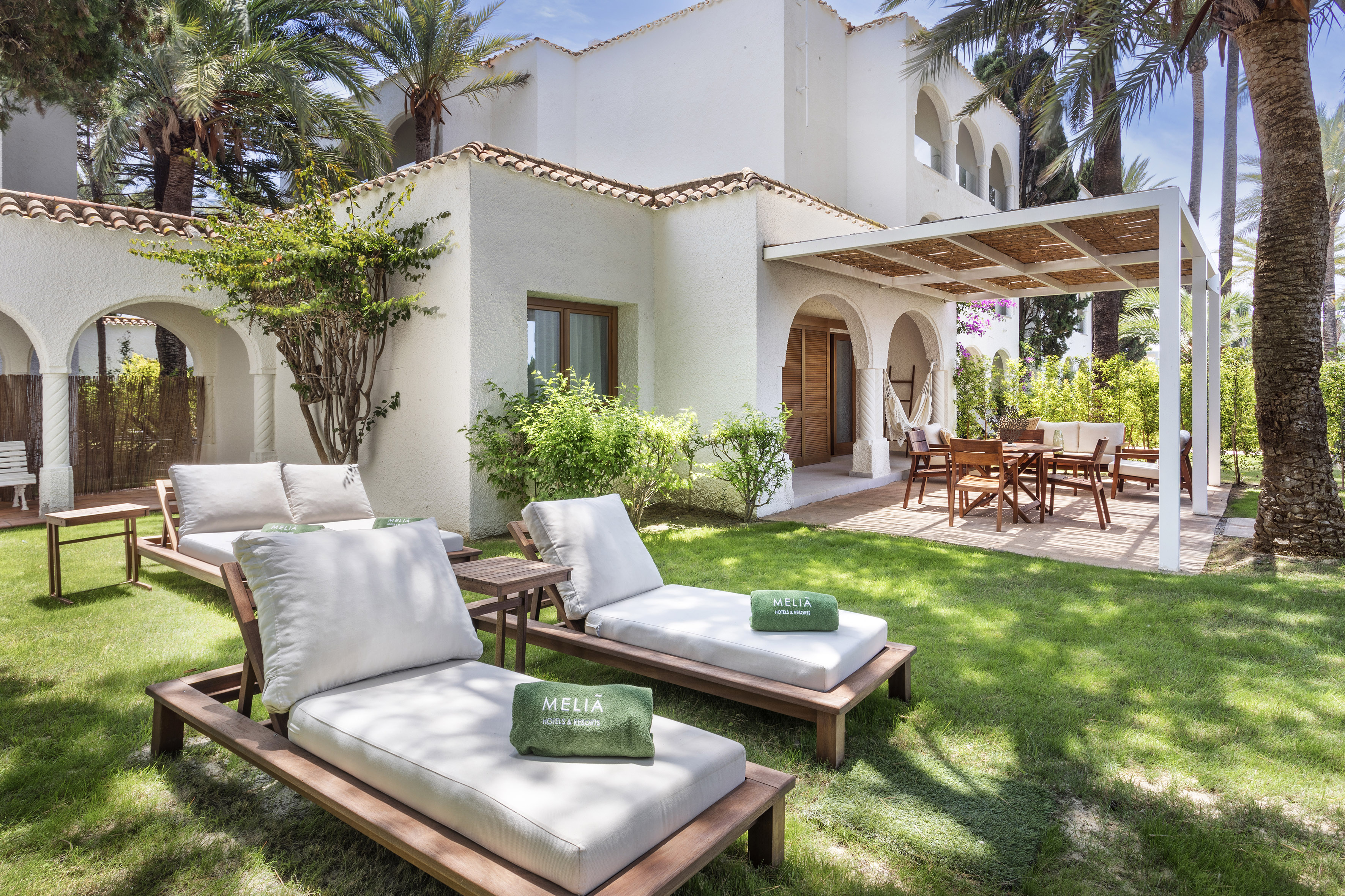 a lawn chairs and a patio in a backyard